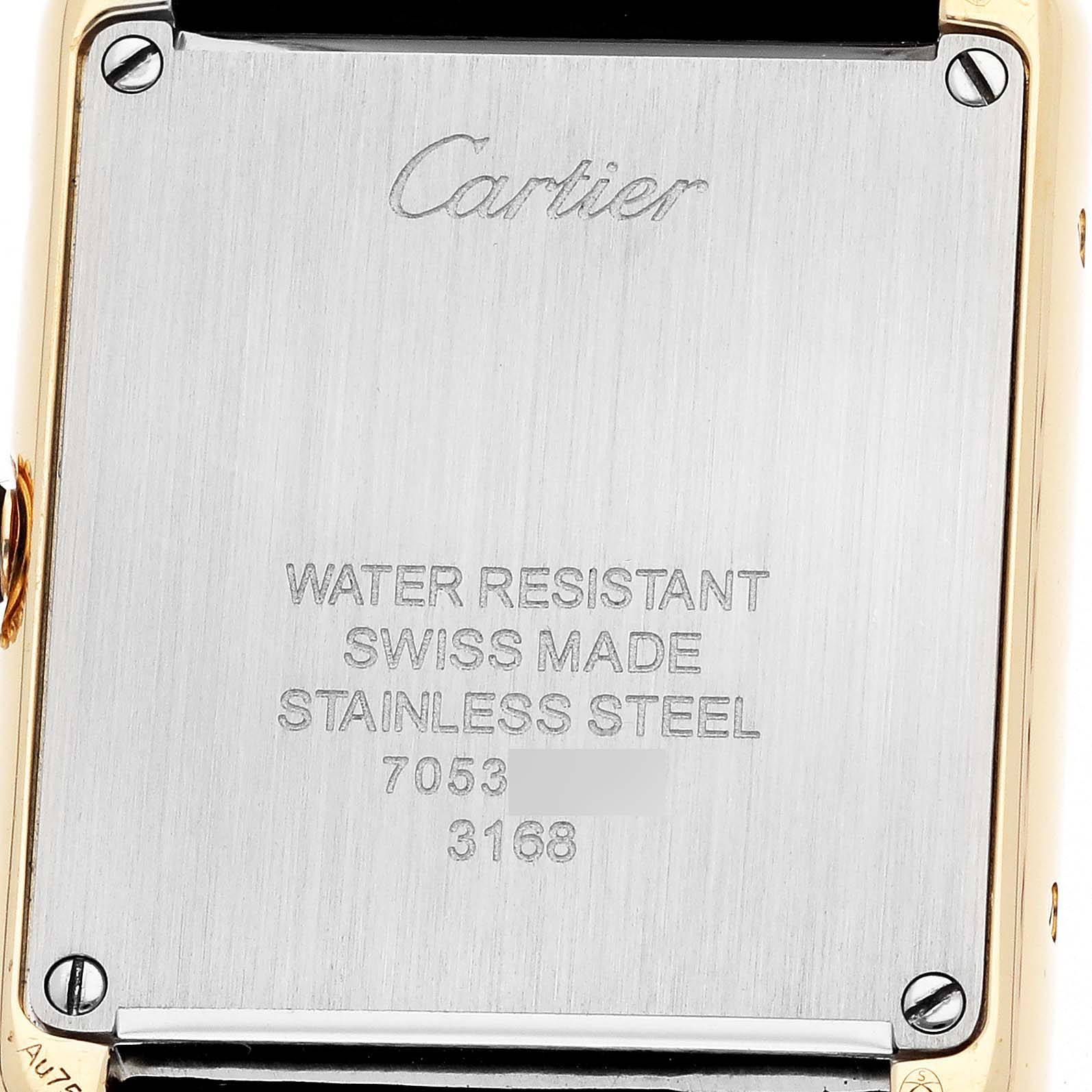 The image shows the back of a Cartier Tank Solo W5200002 Women
s Steel and Gold (two tone) Silver Dial watch, highlighting the engraved details and screws.