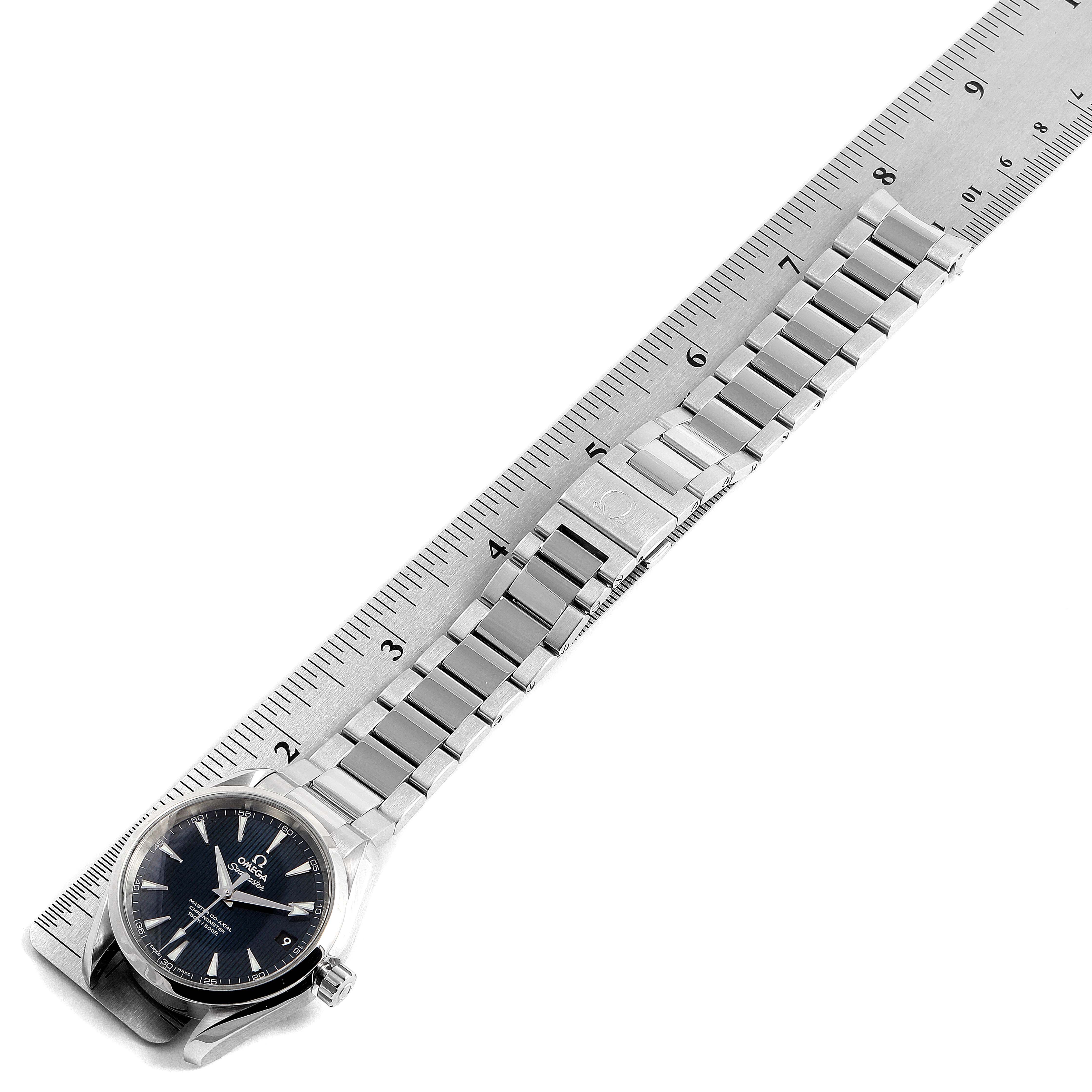 The Omega Aqua Terra 231.10.39.21.03.002 Men
s Stainless Steel Blue Dial 231.10.39.21.03.002 Men
s Stainless Steel Blue Dial watch is shown laying flat next to a ruler, displaying its face, bracelet, and clasp.