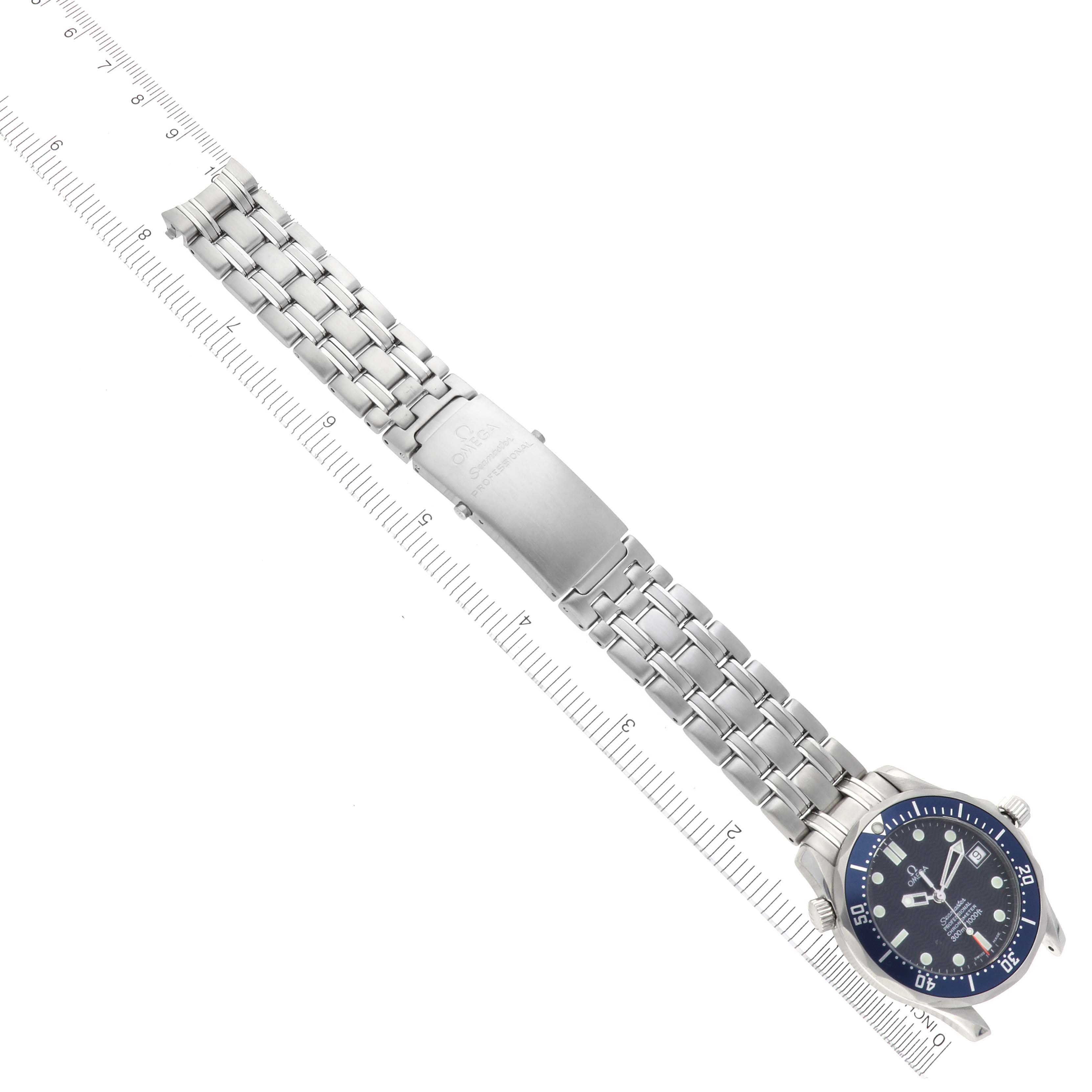 The Omega Seamaster 2551.80.00 Men
s Stainless Steel Blue Dial 2551.80.00 Men
s Stainless Steel Blue Dial is shown from a top-down angle, displaying the full bracelet and clasp alongside a ruler.