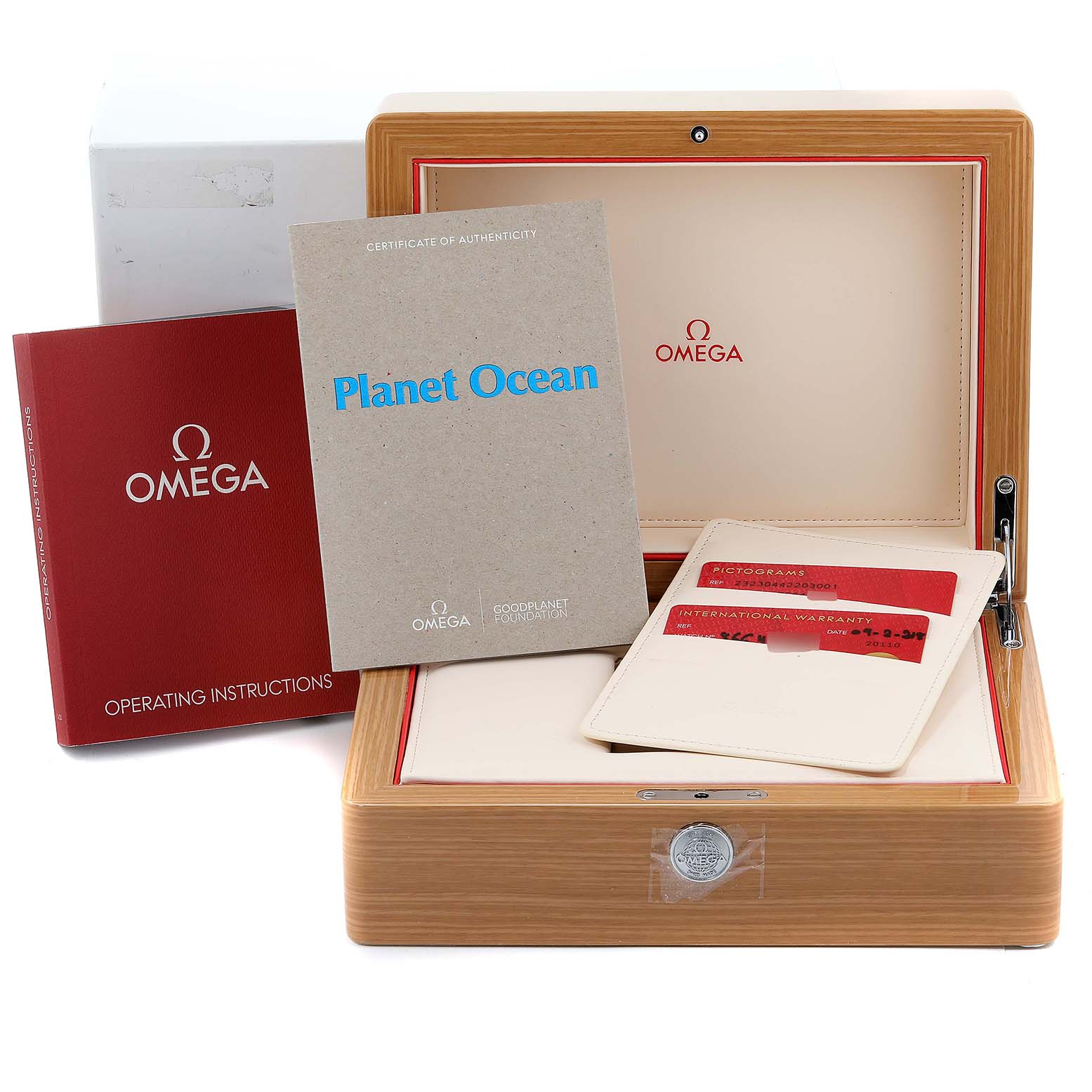 The image shows the packaging and accessories of an Omega Planet Ocean 232.30.44.22.03.001 Men's Stainless Steel Blue Dial 232.30.44.22.03.001 Men's Stainless Steel Blue Dial watch, including the box, warranty cards, and manuals.