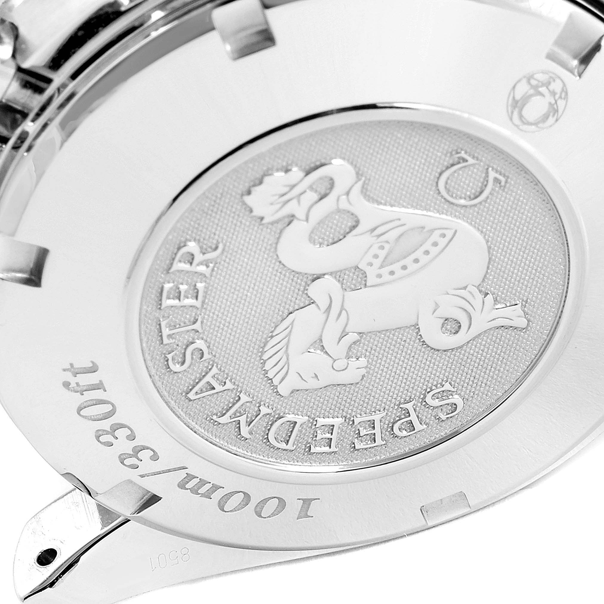 The image shows the back case of an Omega Speedmaster 3220.50.00 Men
s Stainless Steel Black Dial 3220.50.00 Men
s Stainless Steel Black Dial watch, featuring embossed details and engravings.