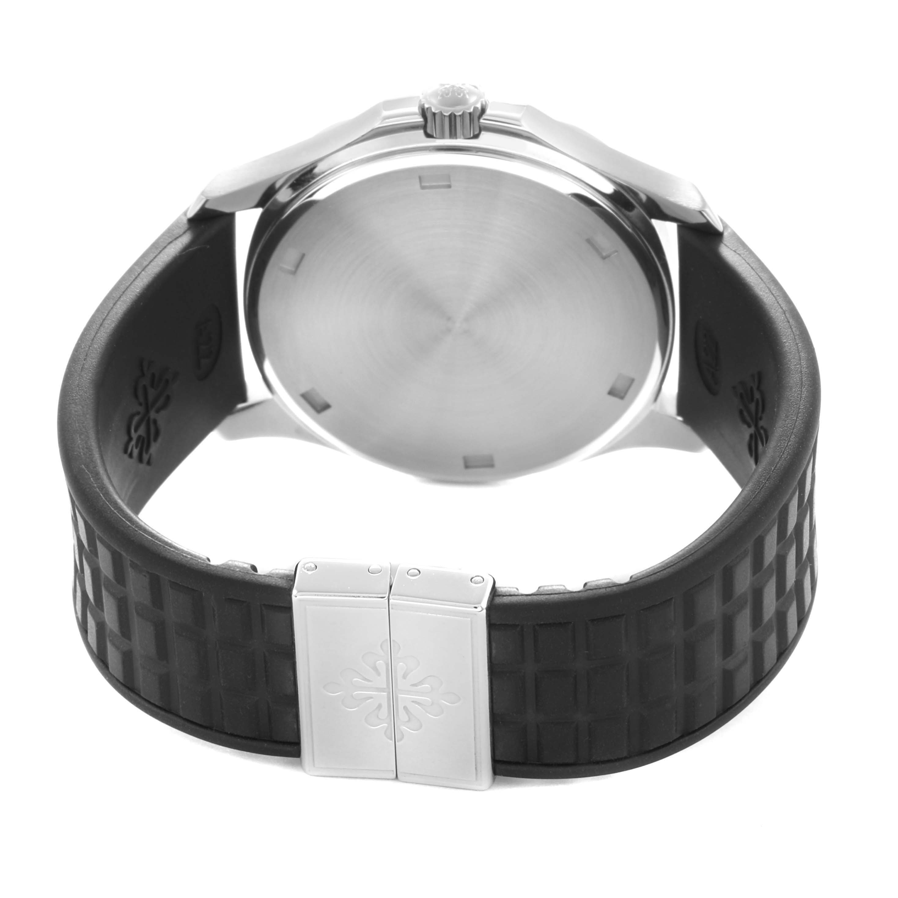 The image shows a side angle of the Patek Philippe Aquanaut 5067A-014 Women
s Stainless Steel Black Dial, displaying the back case and textured strap with clasp.