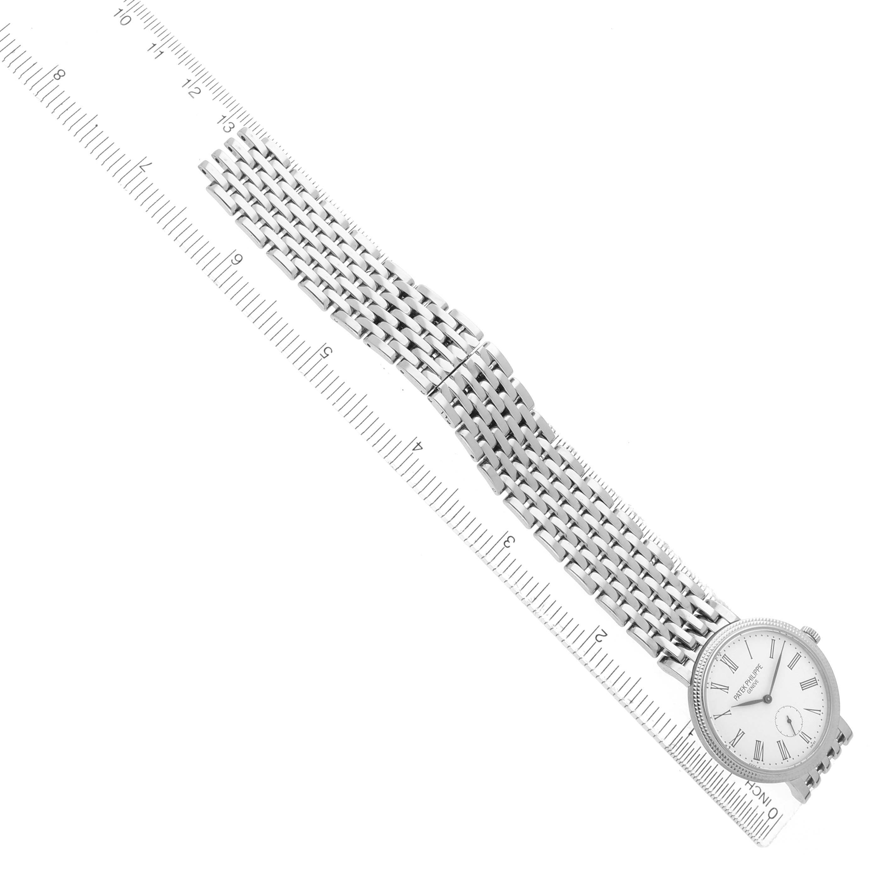 The image shows a Patek Philippe Calatrava 7119G Women
s White Gold White Dial watch from an angled top view, highlighting the dial, bracelet, and clasp.