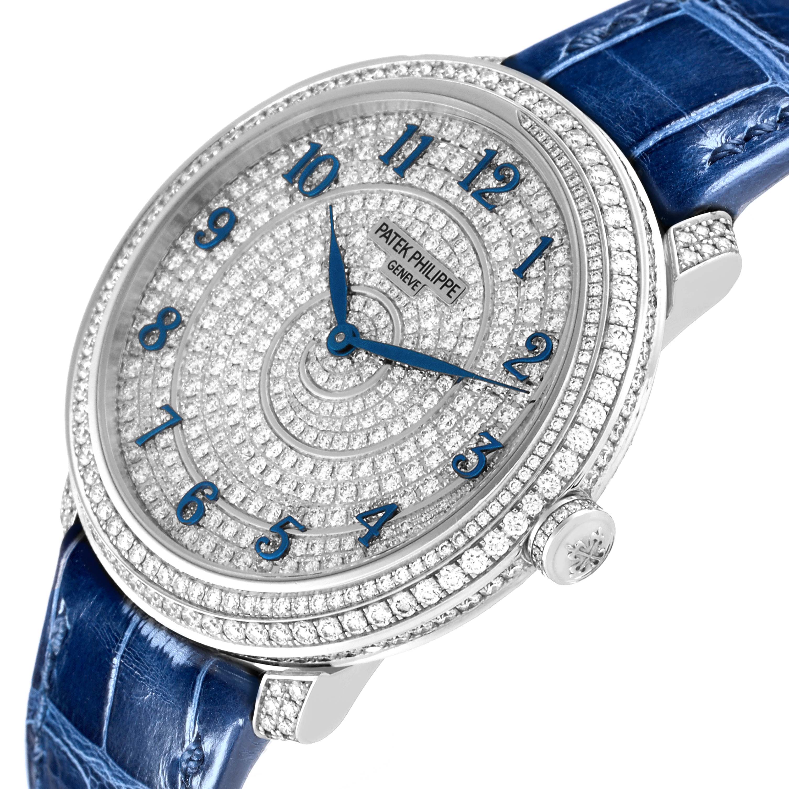 The image shows a close-up angle of a Patek Philippe Calatrava 4978 Women's White Gold Silver Dial 4978 Women's White Gold Silver Dial model watch featuring a diamond-studded dial and a blue leather strap.