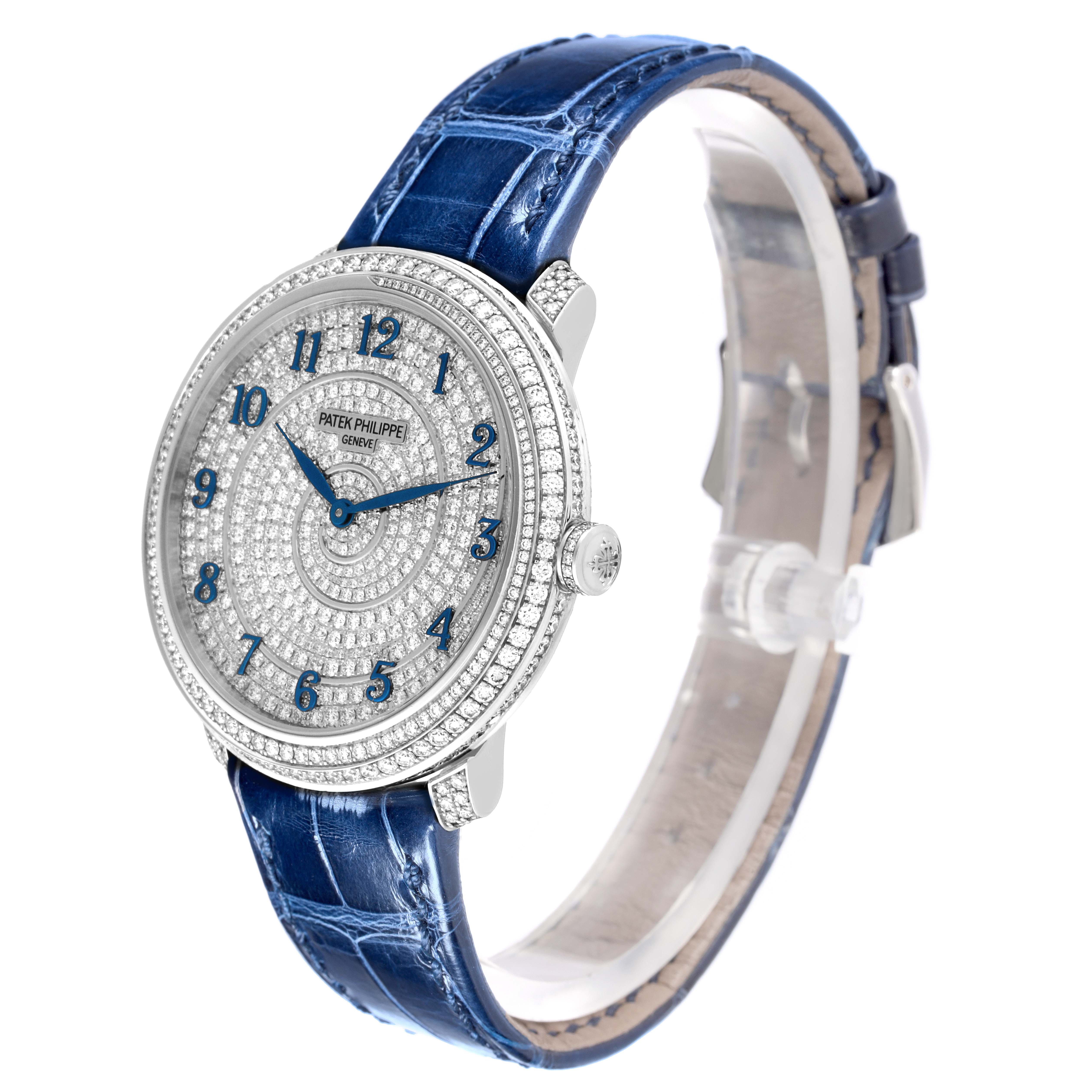 The image shows a side angle of the Patek Philippe Calatrava 4978 Women's White Gold Silver Dial 4978 Women's White Gold Silver Dial watch, highlighting its diamond-studded dial and blue leather strap.