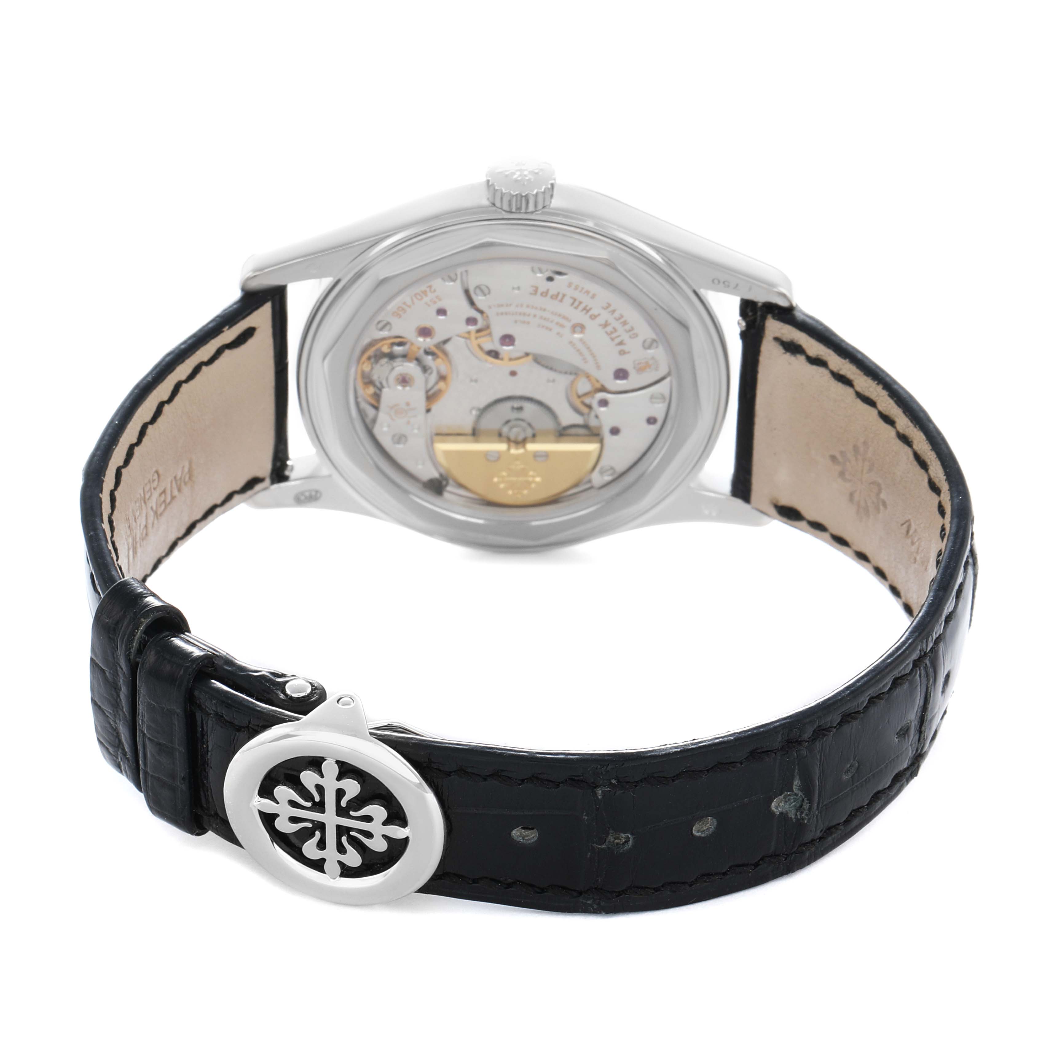 The Patek Philippe Calatrava 6000G-010 Men
s White Gold Black Dial watch is shown from a rear angle, highlighting its open case back and leather strap.