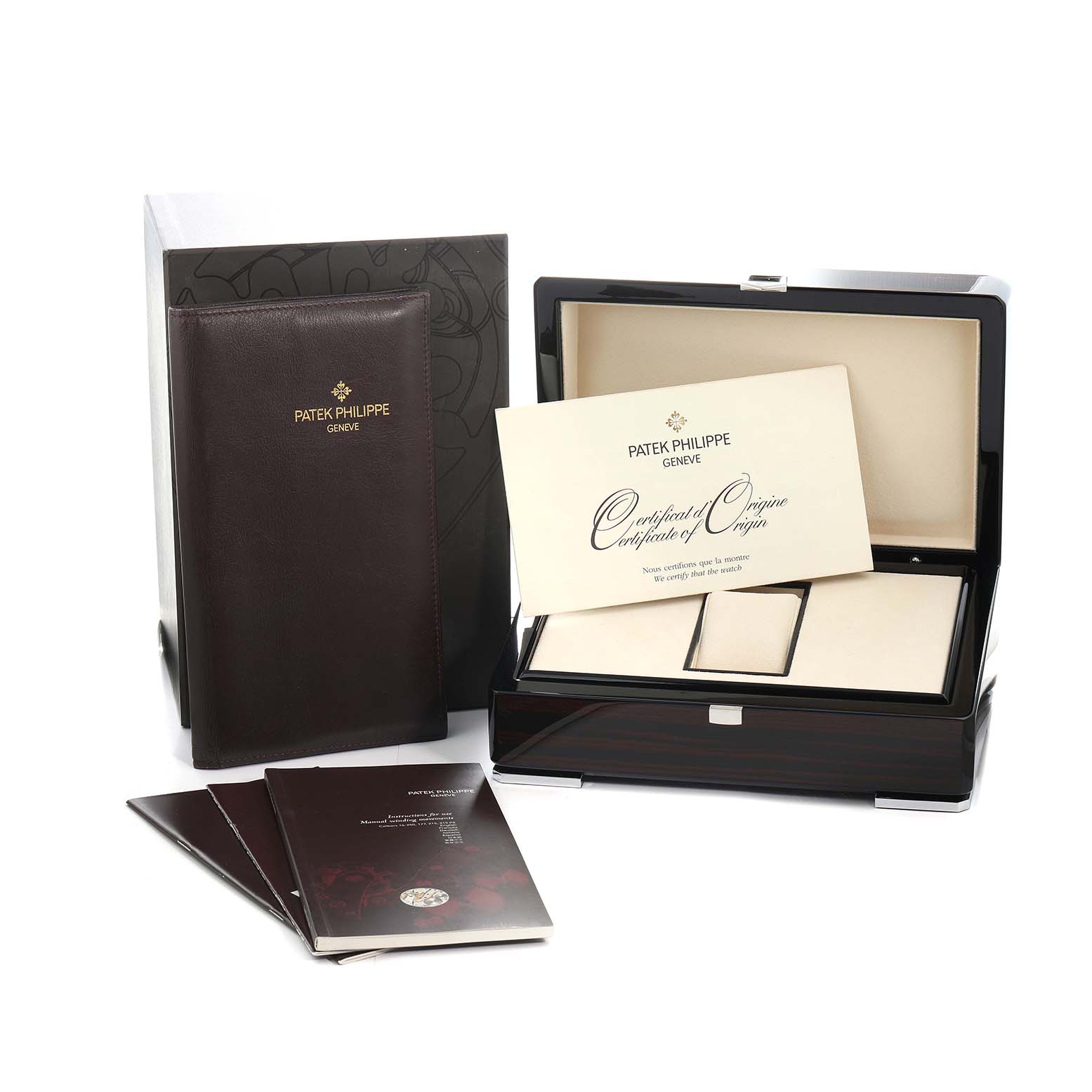 The image shows the Patek Philippe Calatrava 6000G-010 Men
s White Gold Black Dial box, certificate, and manuals from a front angle.