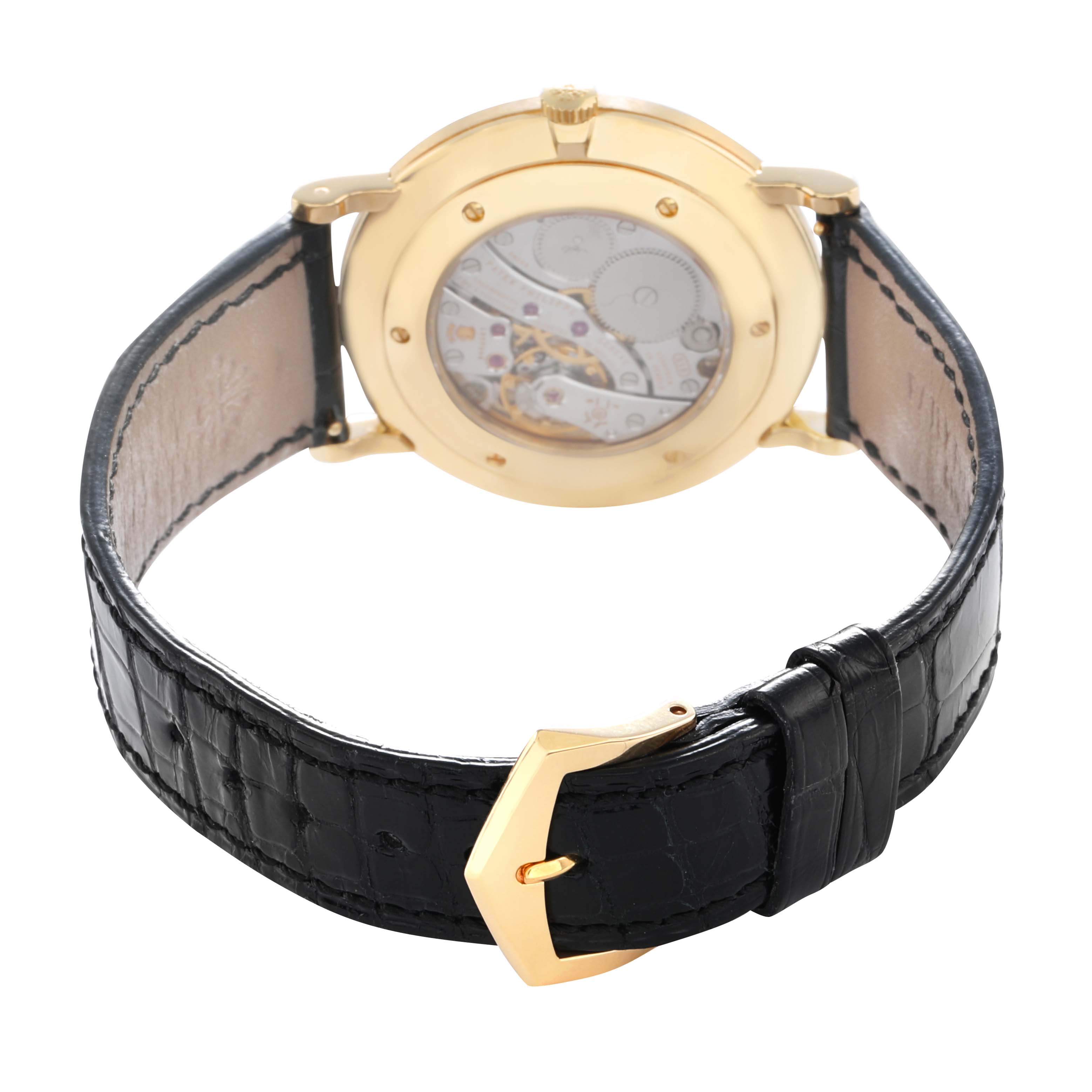 The Patek Philippe Calatrava 5119J-001 Men
s Yellow Gold White Dial watch is shown from the back, highlighting its transparent case back and leather strap.