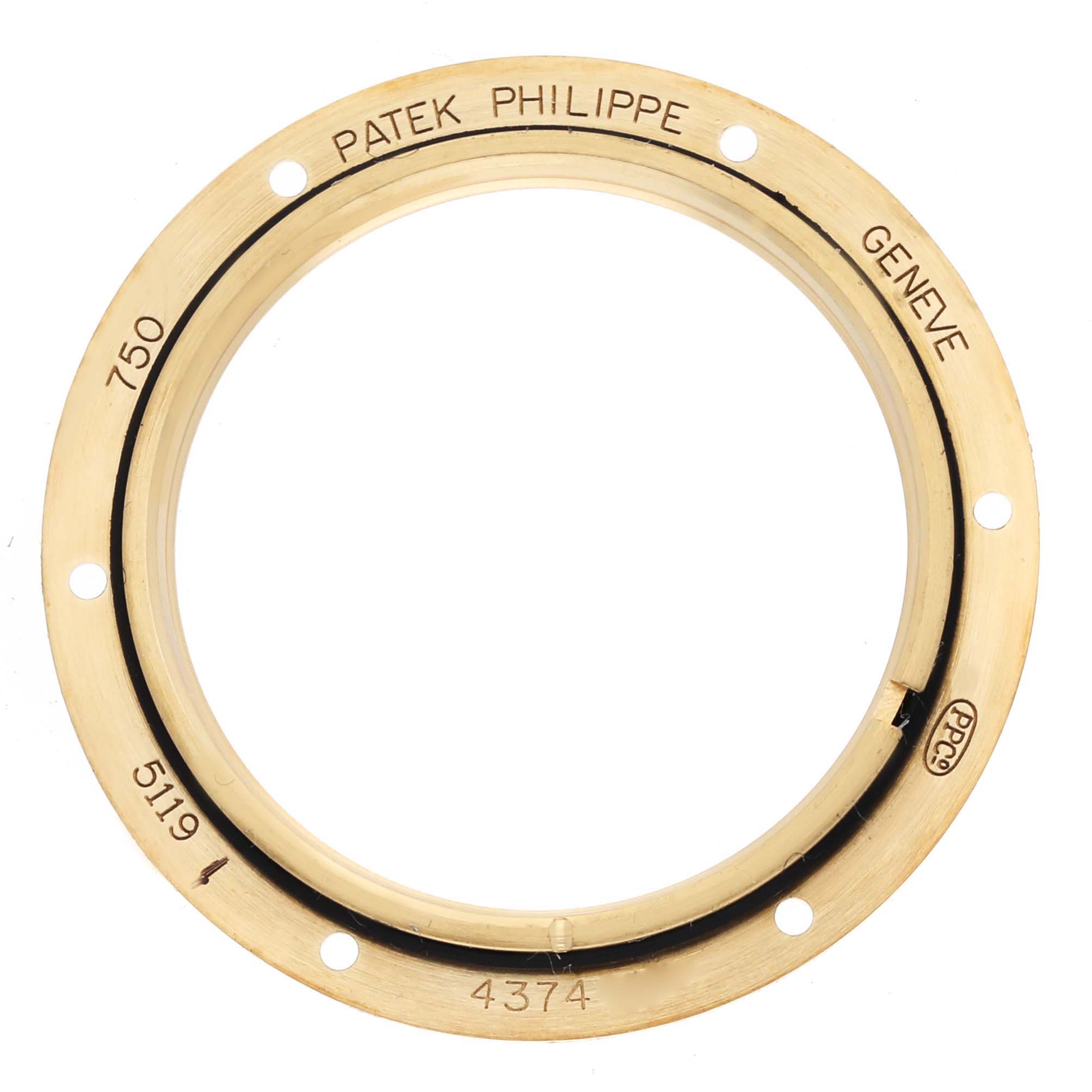 This image shows a bird
s-eye view of a Patek Philippe Calatrava 5119J-001 Men
s Yellow Gold White Dial watch bezel, highlighting the engravings and circular holes.