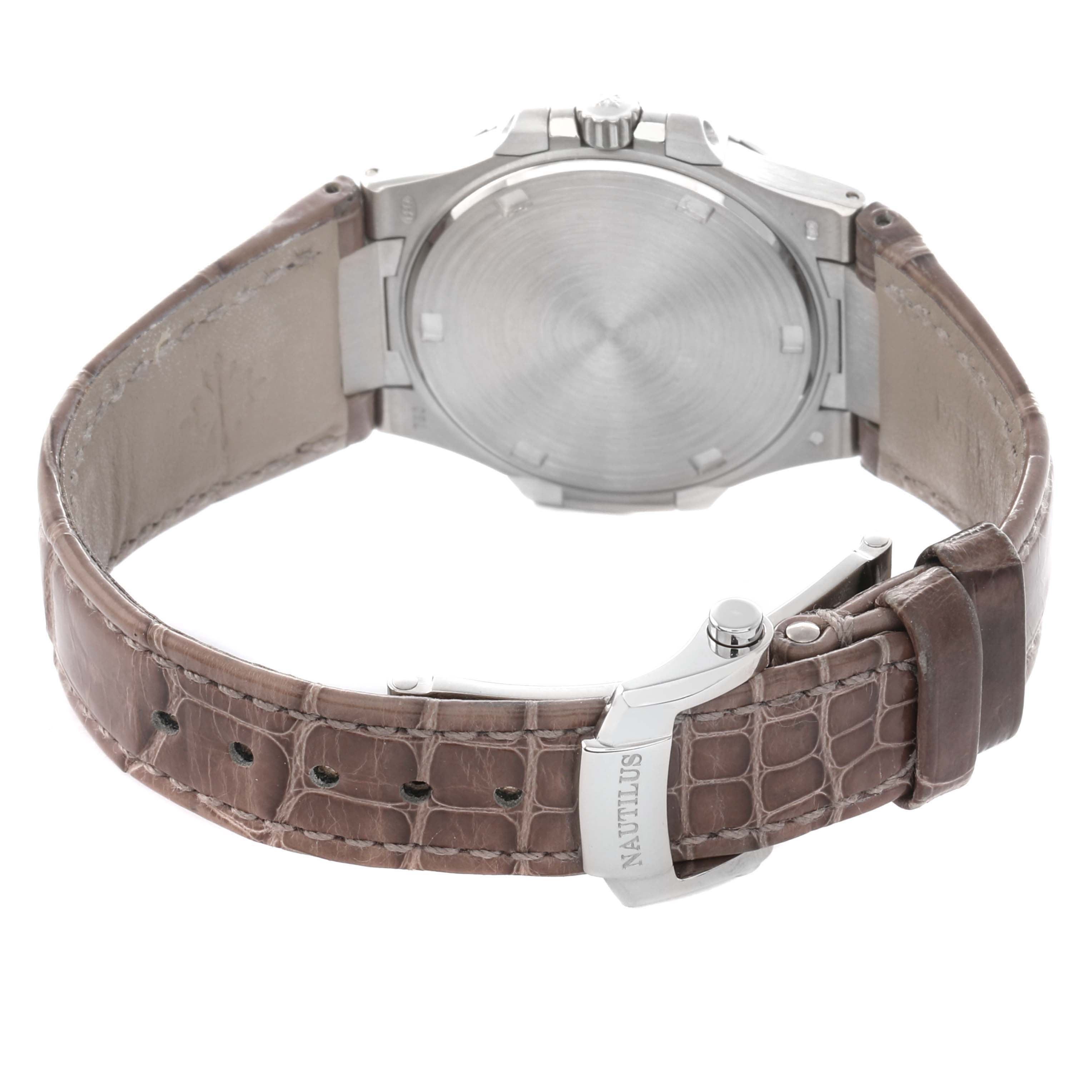 The image shows a rear view of a Patek Philippe Nautilus 7010G-010 Women
s White Gold Silver Dial, highlighting its closed case back and leather strap with the buckle.