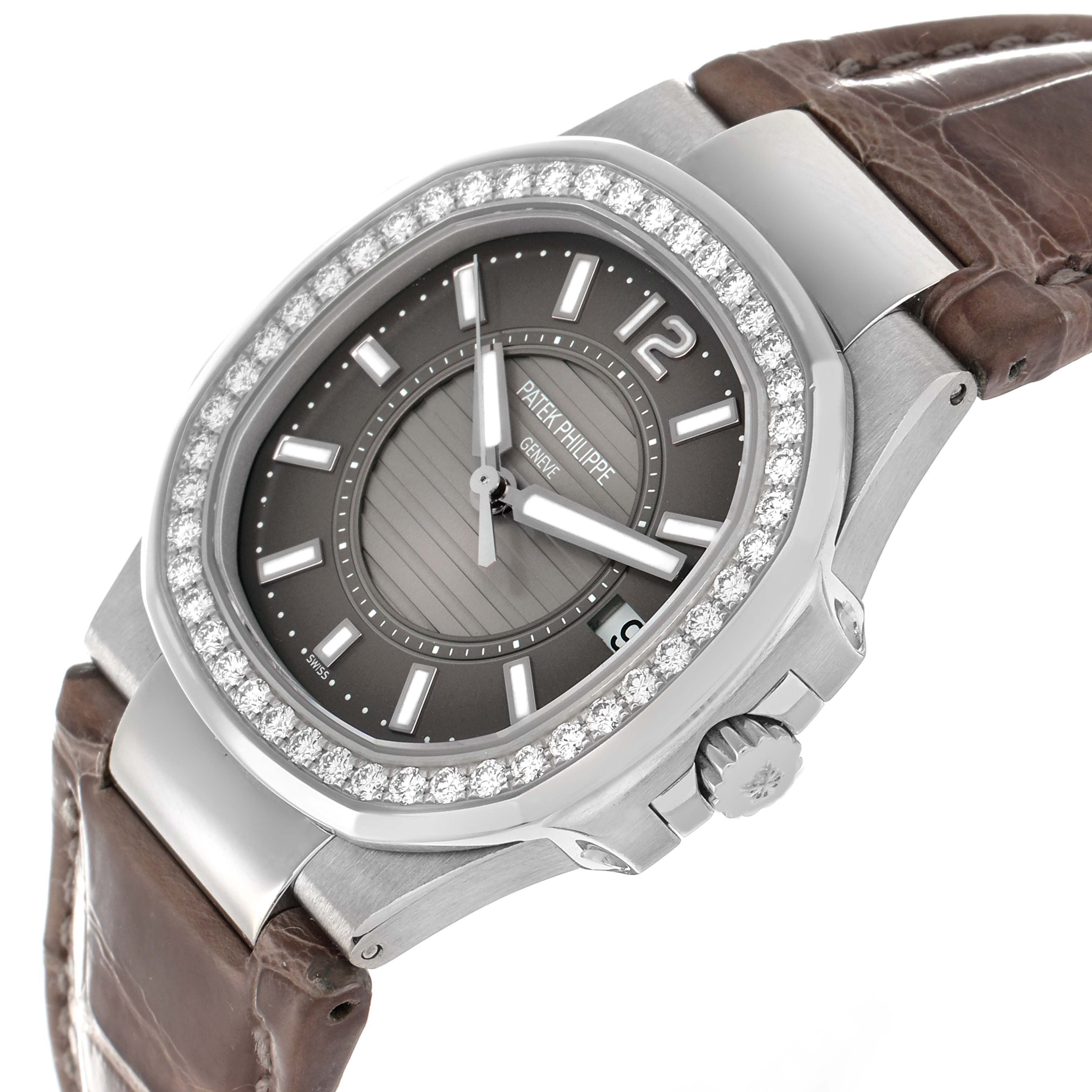 The Patek Philippe Nautilus 7010G-010 Women
s White Gold Silver Dial watch is shown at an angled view, featuring the face, bezel, crown, and part of the leather strap.