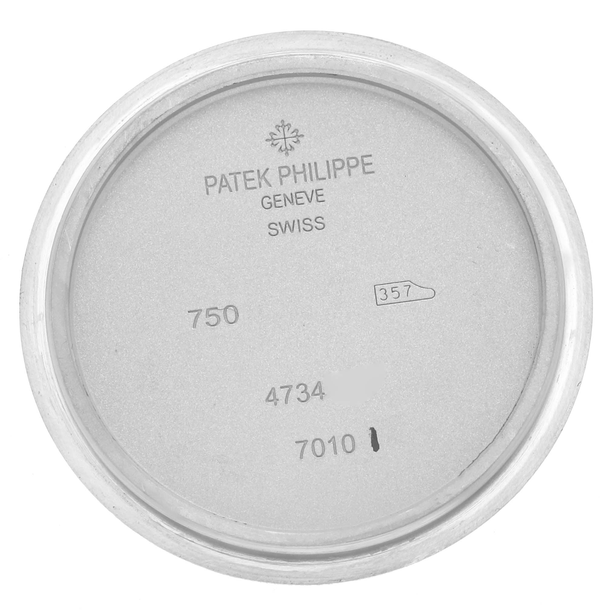 The image shows the back case of a Patek Philippe Nautilus 7010G-010 Women
s White Gold Silver Dial watch with engraved model and production details.