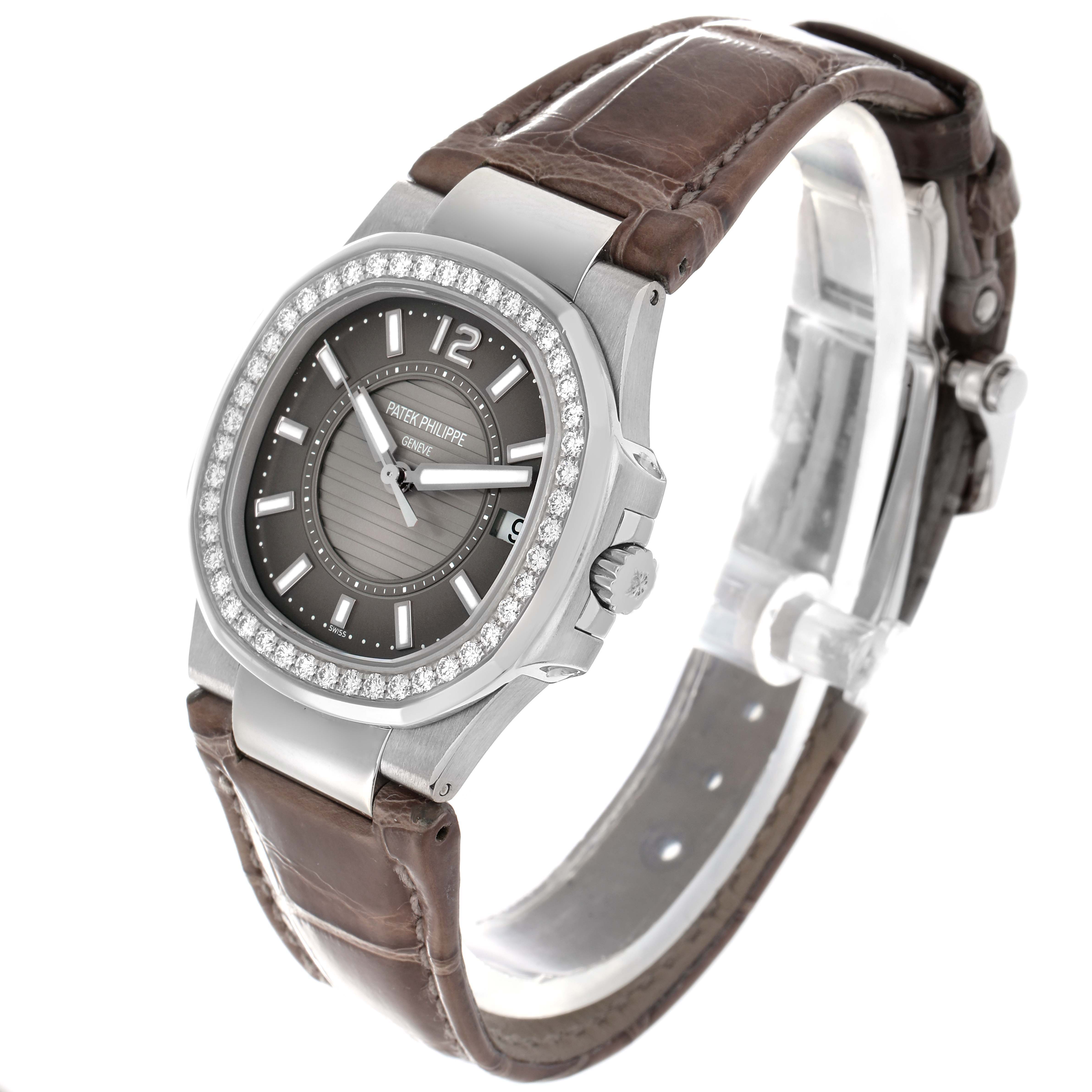 The Patek Philippe Nautilus 7010G-010 Women
s White Gold Silver Dial watch is shown at a three-quarter angle, featuring the face, bezel, brown strap, and crown.