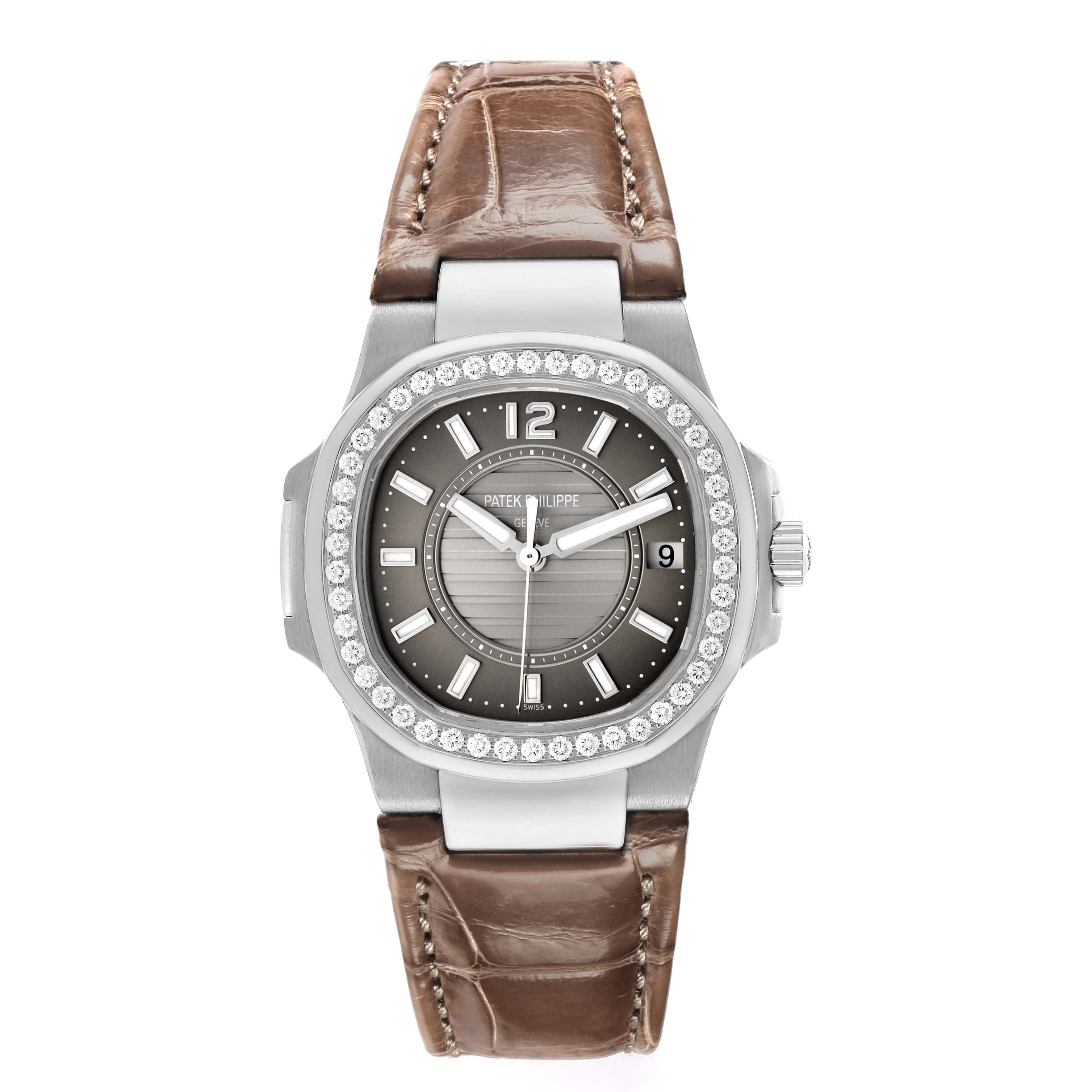The Patek Philippe Nautilus 7010G-010 Women
s White Gold Silver Dial watch is shown from the front, featuring a diamond bezel, gray dial, and brown leather strap.