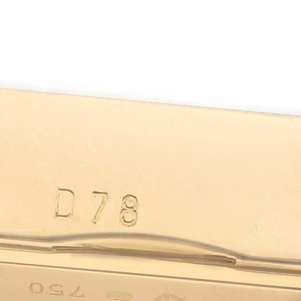 The image shows a close-up of the gold clasp or bracelet of a Rolex Cellini 5440 Men
s Yellow Gold Champagne Dial watch, highlighting engraved details.