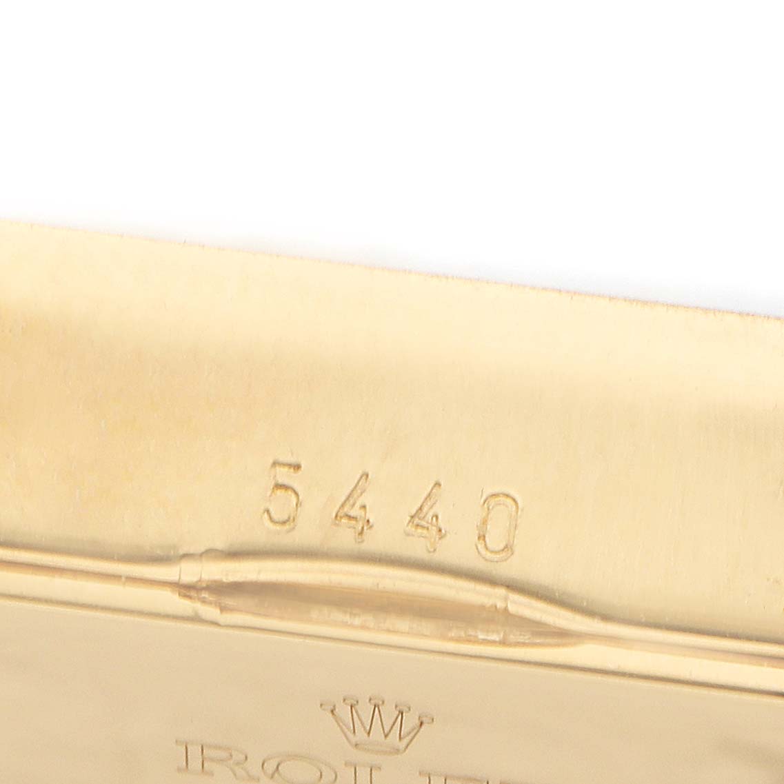 The image shows the back of a Rolex Cellini 5440 Men
s Yellow Gold Champagne Dial watch case with the model number "5440" engraved on it.