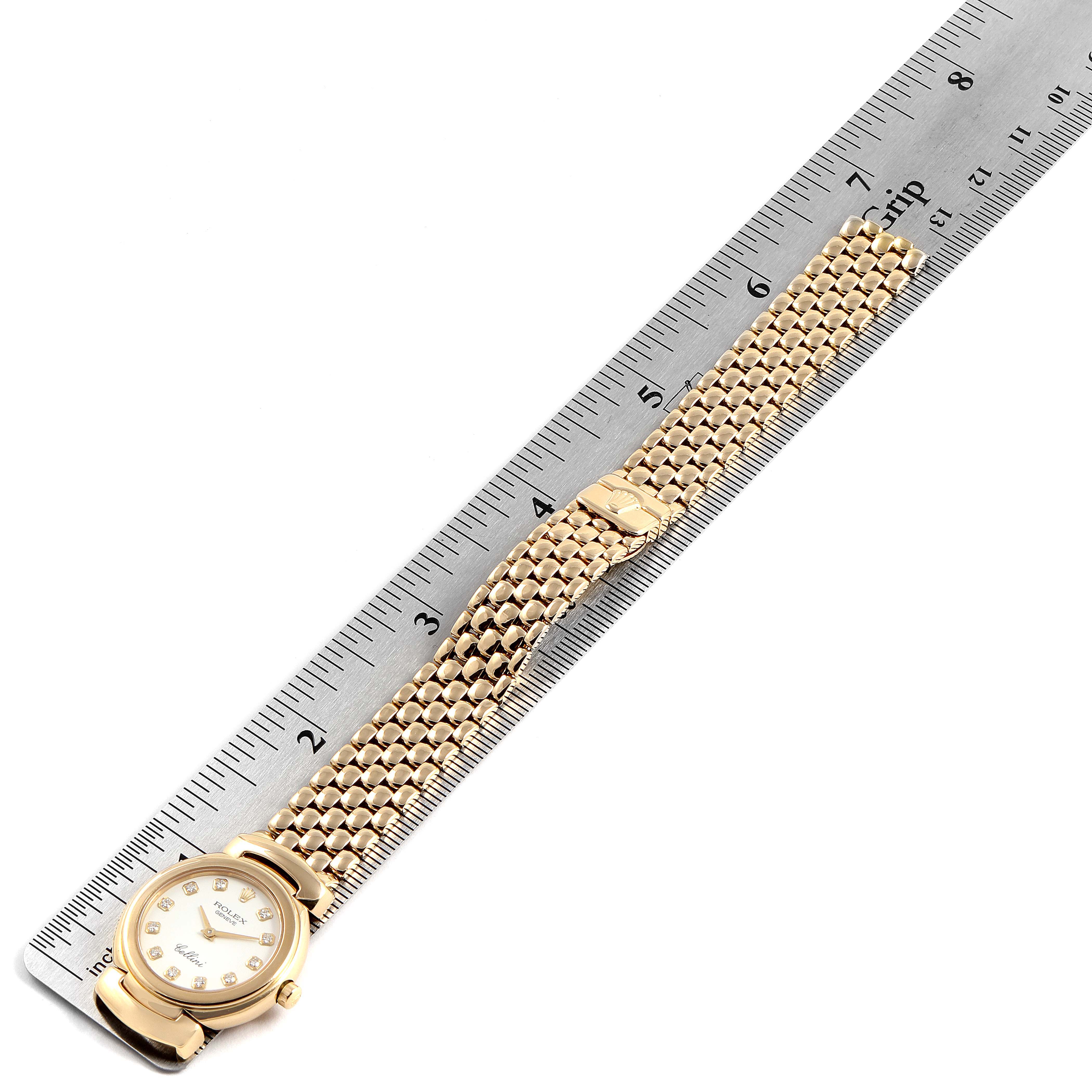 This image shows a Rolex Cellini 6621 Women's Yellow Gold White Dial 6621 Women's Yellow Gold White Dial watch laid flat with its full bracelet extended alongside a ruler for measurement.