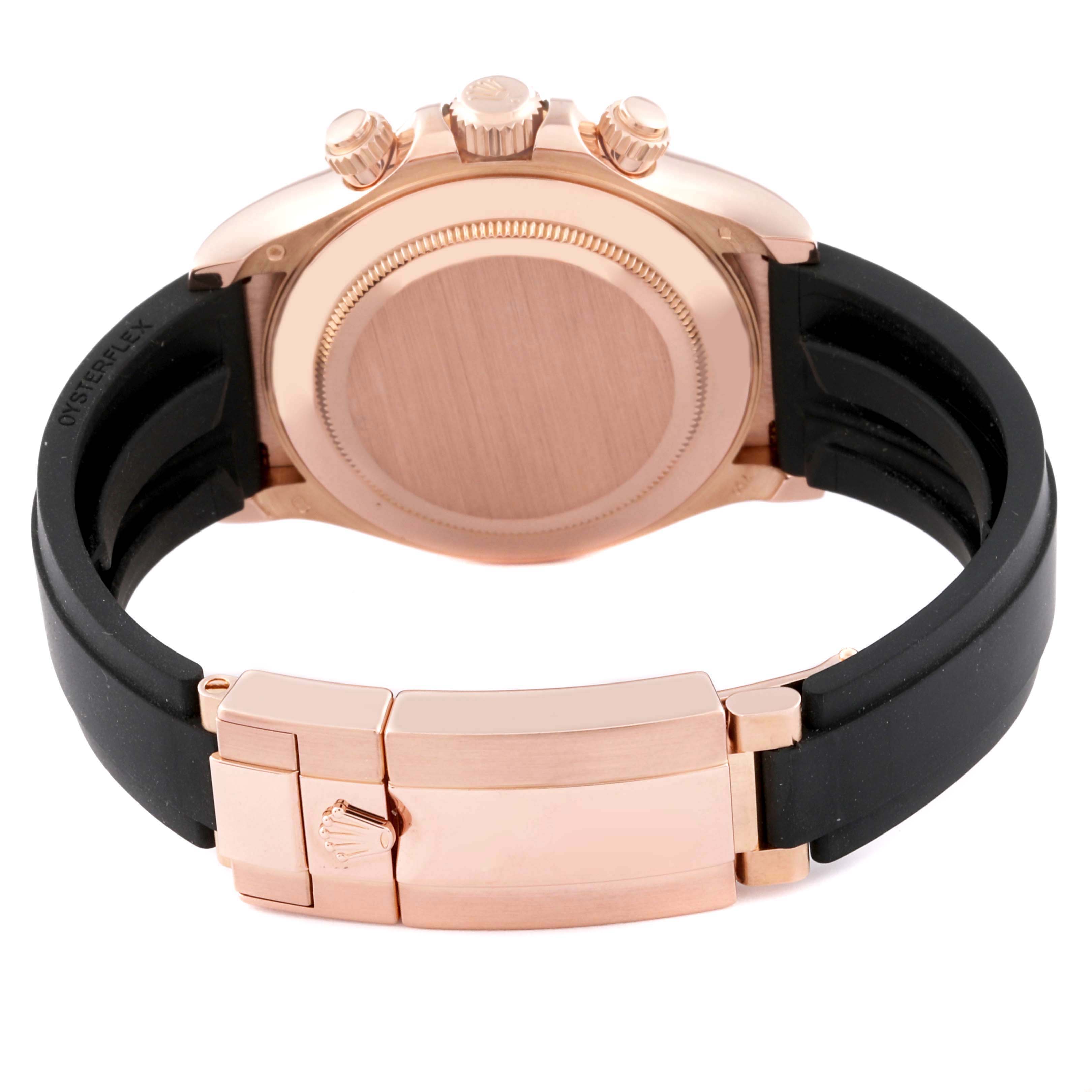 The image shows the back view of a Rolex Daytona 116515LN Men's Rose Gold Brown Dial 116515LN Men's Rose Gold Brown Dial watch, including the case back, clasp, and rubber strap.