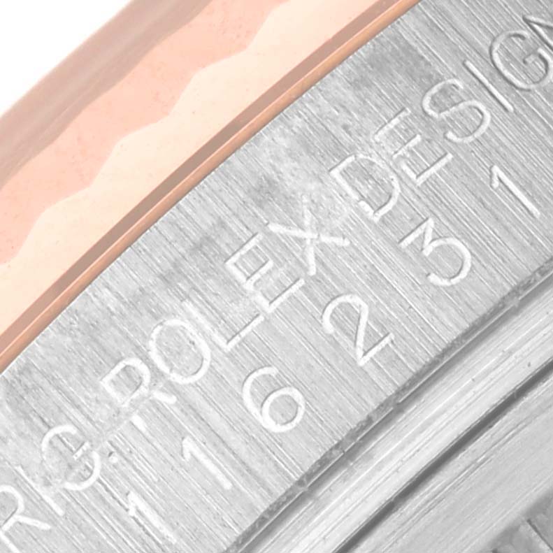 This is a close-up of the inner bezel and case, showing the engraved serial number and "ROLEX" text on a Datejust model by Rolex.