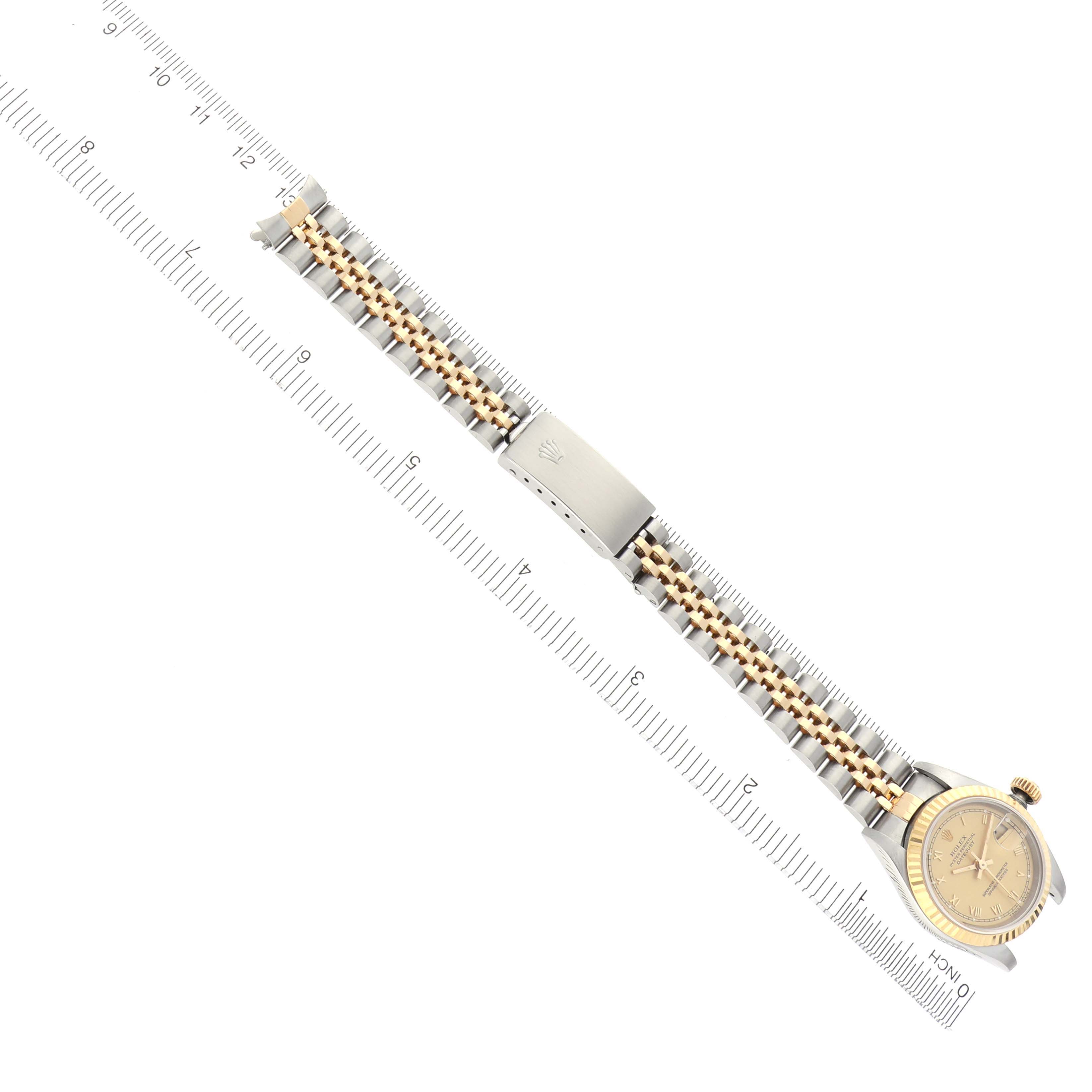 The image shows a top-down view of a Rolex Datejust 69173 Women
s Steel and Gold (two tone) Champagne Dial 69173 Women
s Steel and Gold (two tone) Champagne Dial watch, displaying the entire watch and bracelet laid out next to a measuring ruler.