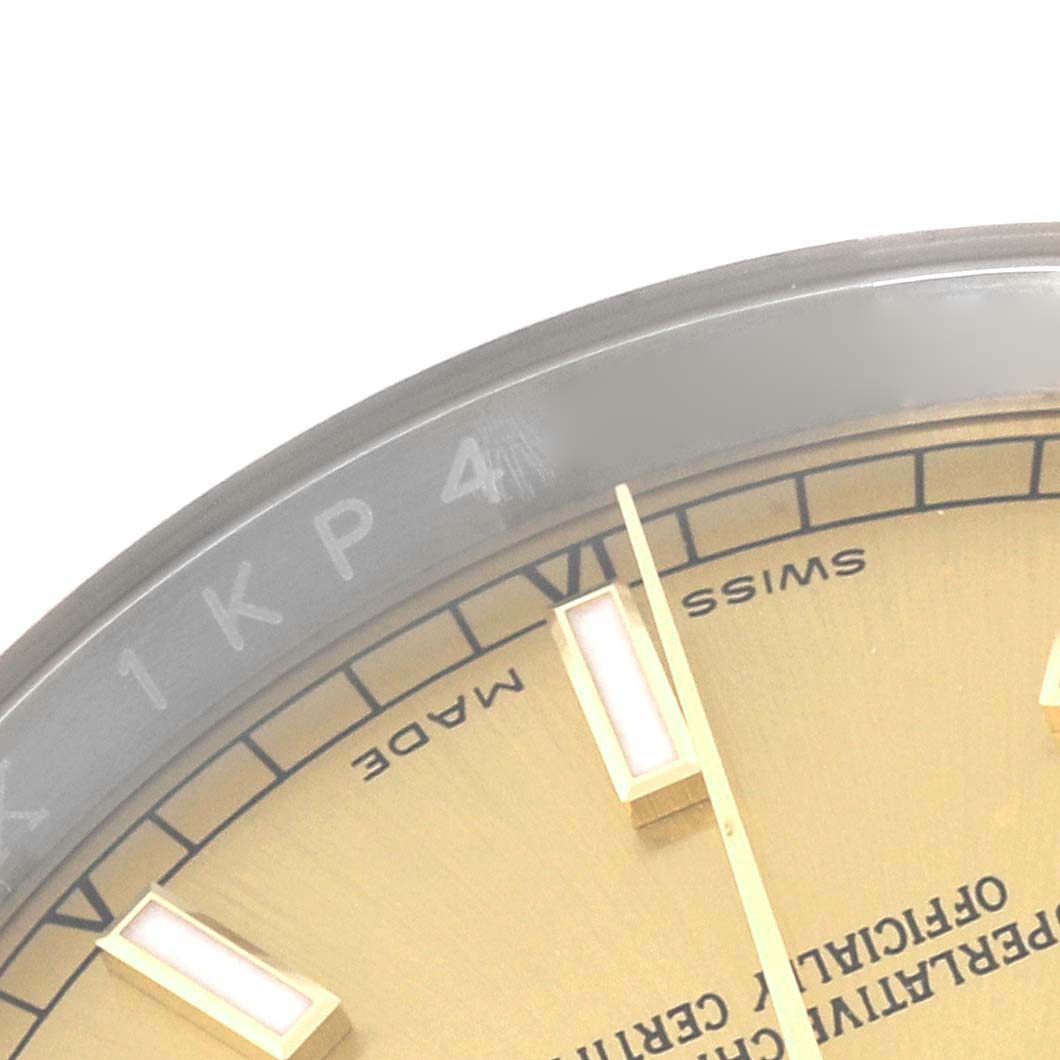 Close-up of the bezel and part of the dial of a Rolex Datejust 116233 Men
s Steel and Gold (two tone) Champagne Dial 116233 Men
s Steel and Gold (two tone) Champagne Dial 41, showing the "Swiss Made" text and some hour markers.