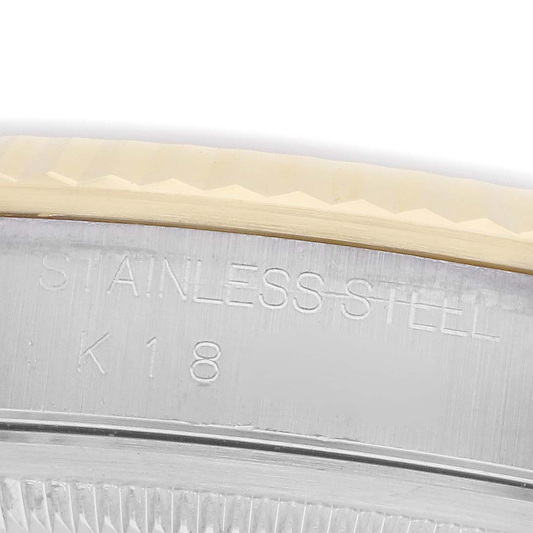 The image shows a close-up of the stainless steel and gold fluted bezel of a Rolex Datejust 16233 Men
s Steel and Gold (two tone) Mother of Pearl Dial.