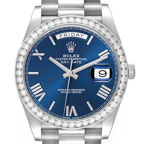 The Rolex President model is shown from a front angle, displaying its blue dial, diamond bezel, and day-date features.