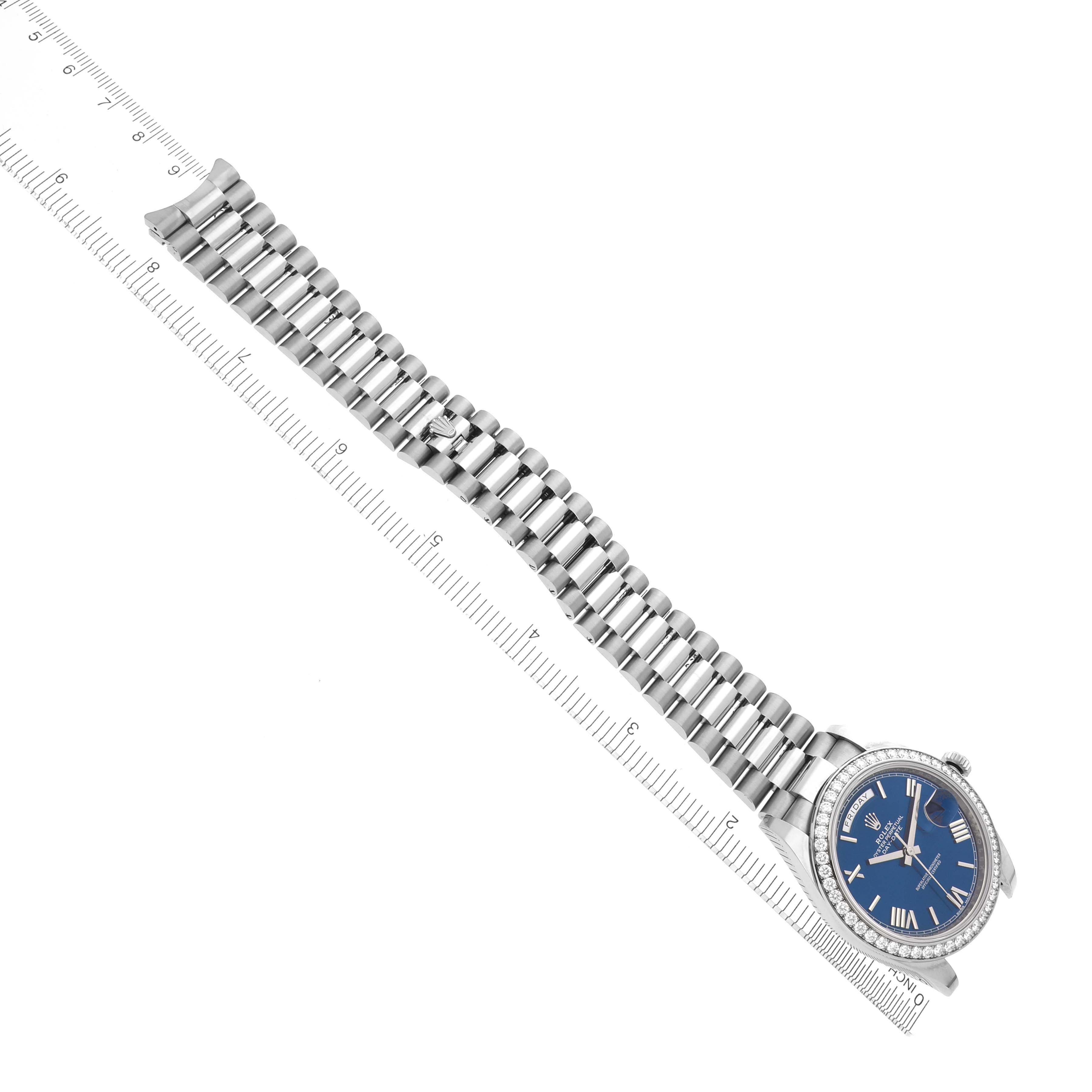 The Rolex President 228349RBR Men's White Gold Blue Dial 228349RBR Men's White Gold Blue Dial watch features a top view showing the full bracelet and face, with a ruler for scale.