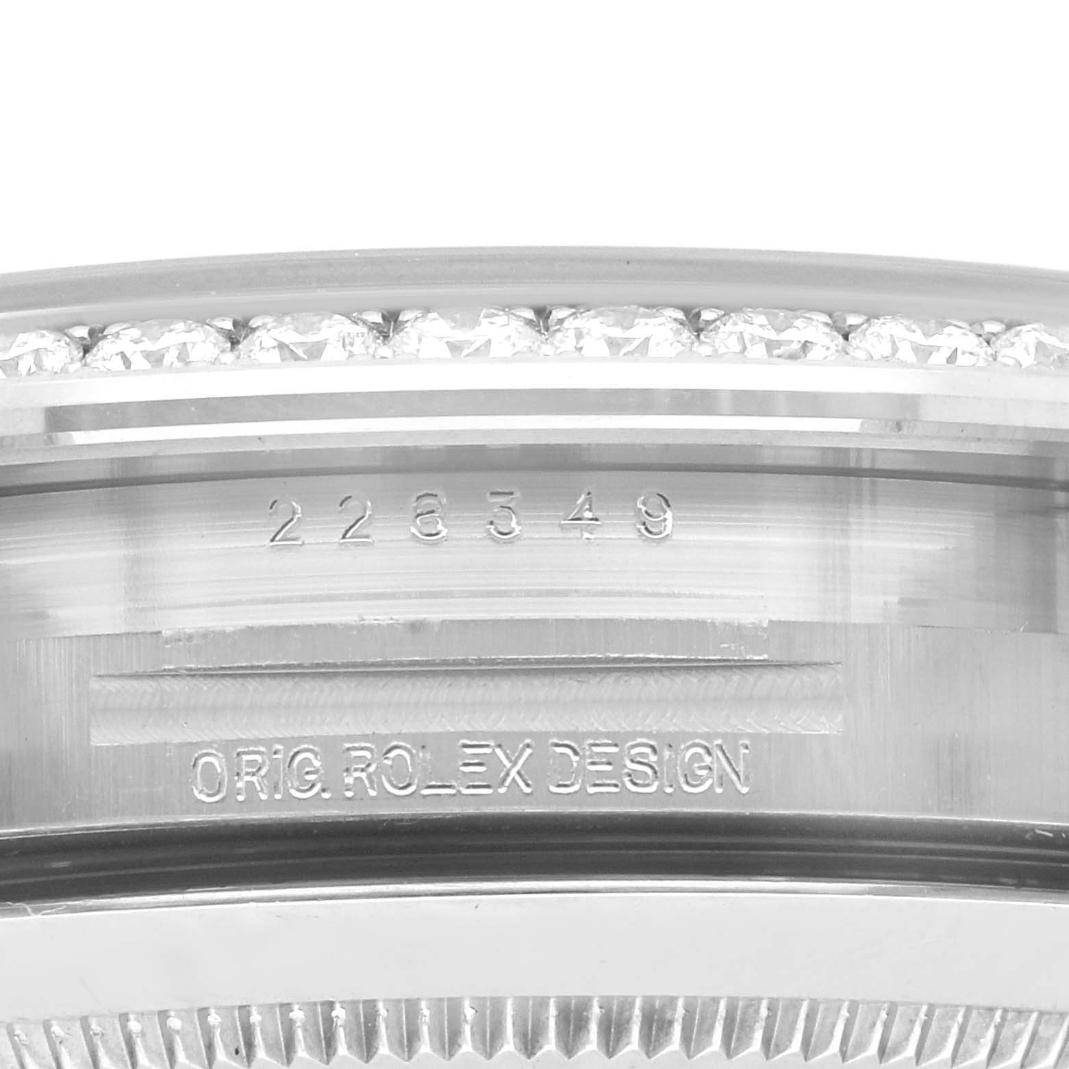 This close-up angle shows the engraved bezel and serial number area of a Rolex President 228349RBR Men's White Gold Blue Dial 228349RBR Men's White Gold Blue Dial model.