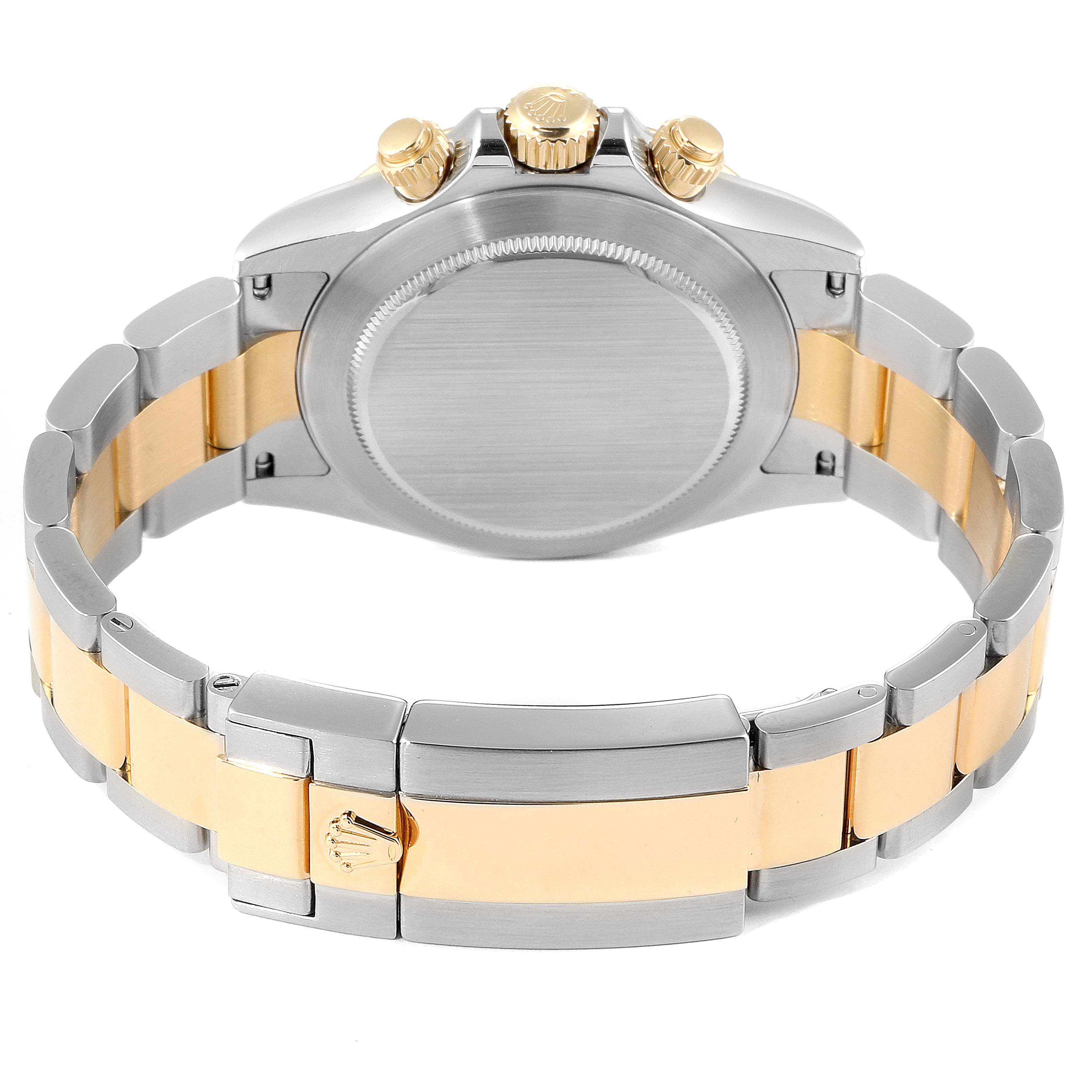 This image shows the back and bracelet of a Rolex Daytona 116523 Men's Steel and Gold (two tone) Blue Dial 116523 Men's Steel and Gold (two tone) Blue Dial watch, highlighting the clasp and crown.