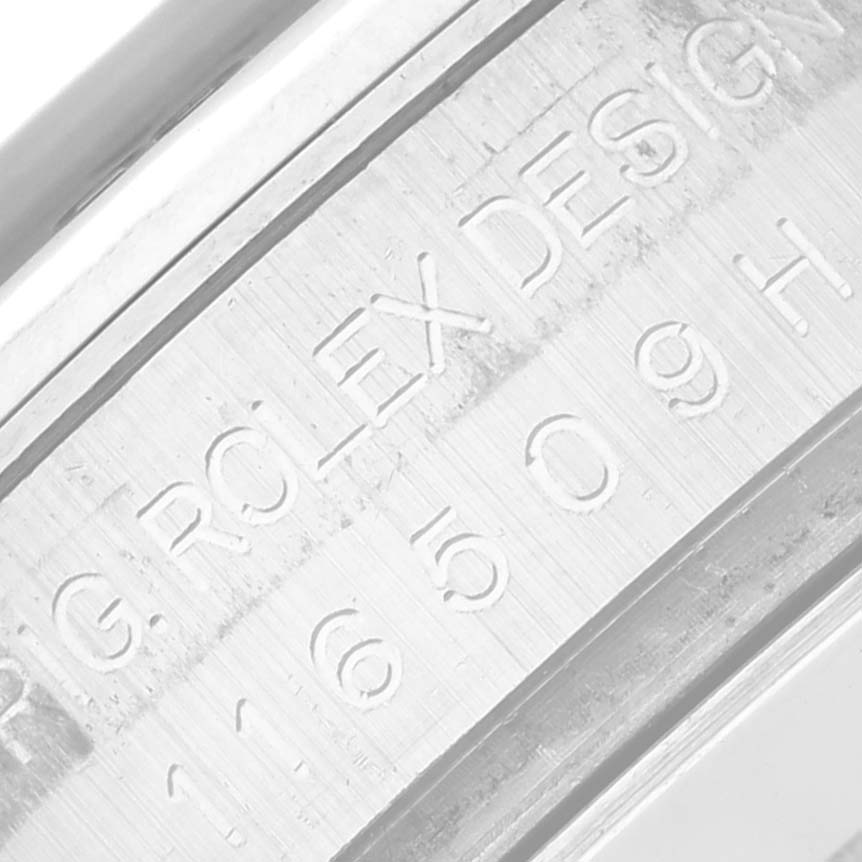 The image shows a close-up of the engraved reference number and "Rolex Design" on the case side of a Rolex Daytona 116509 Men's White Gold Silver Dial 116509 Men's White Gold Silver Dial watch.