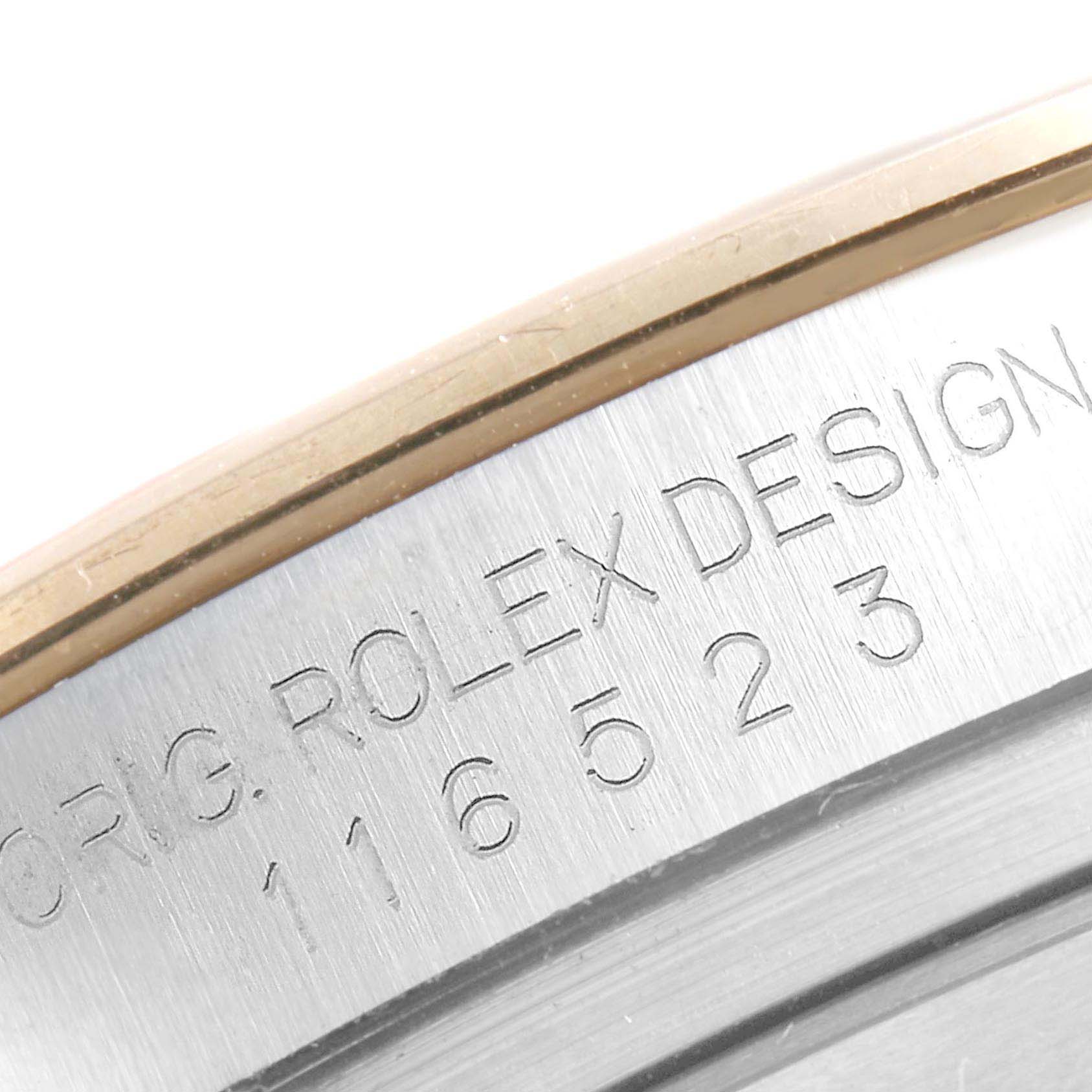 This image shows a close-up of the serial number engraving on the side of a Rolex Daytona 116523 Men's Steel and Gold (two tone) Mother of Pearl Dial 116523 Men's Steel and Gold (two tone) Mother of Pearl Dial watch case.