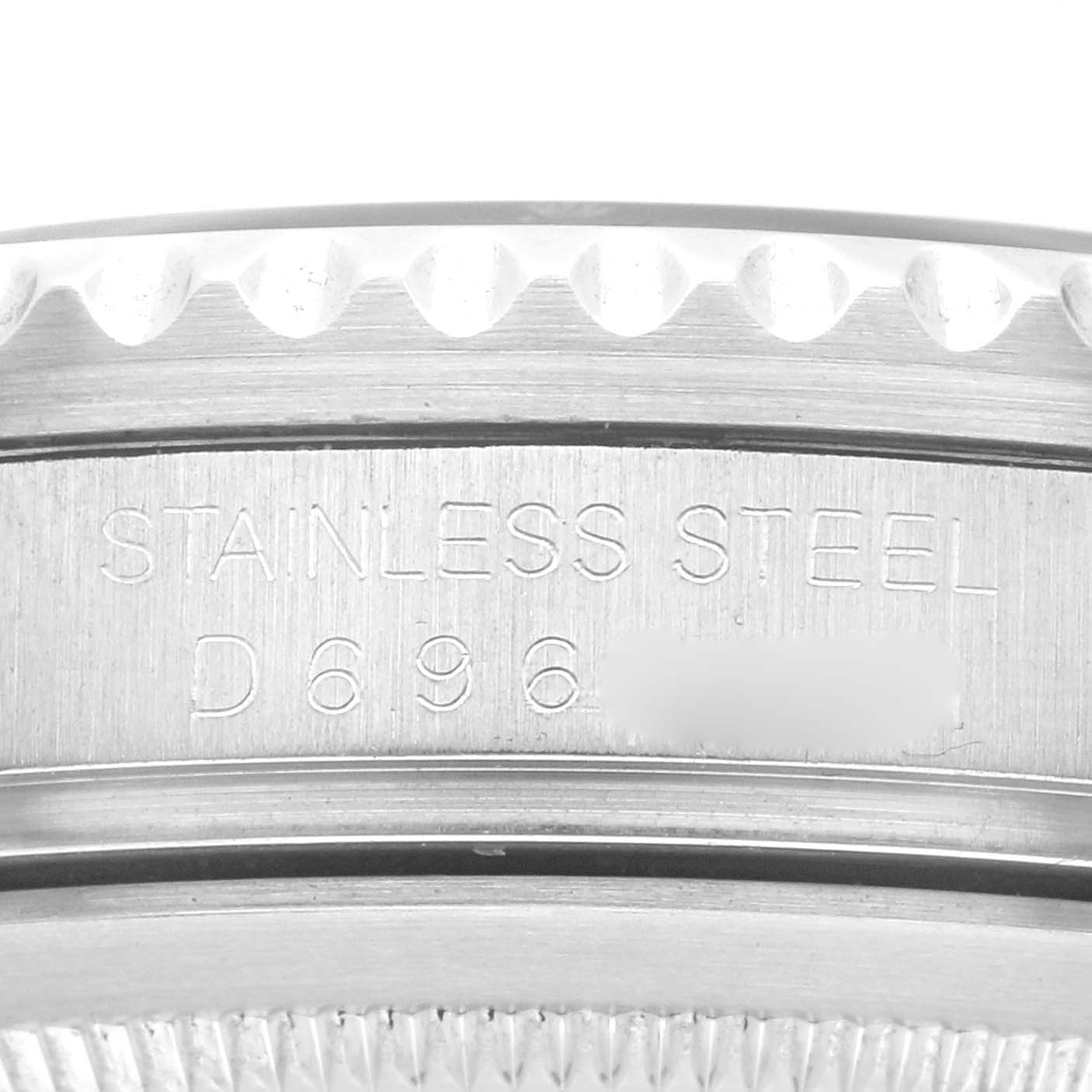 The image shows a close-up of the side of a Rolex GMT-Master 16710 Men's Stainless Steel Black Dial 16710 Men's Stainless Steel Black Dial, featuring the "STAINLESS STEEL" engraving and partial serial number.