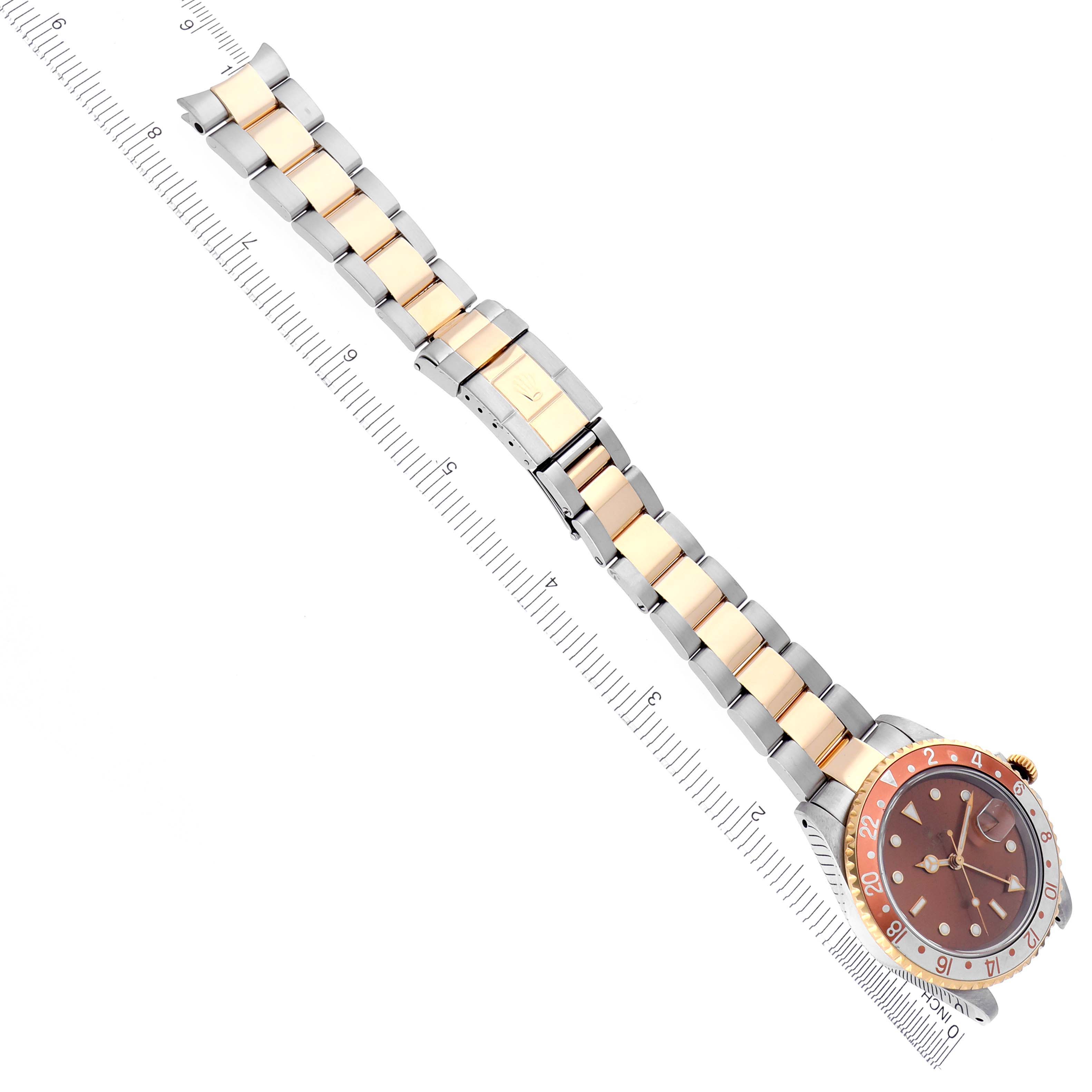 The image shows a Rolex GMT-Master 16713 Men's Steel and Gold (two tone) Brown Dial 16713 Men's Steel and Gold (two tone) Brown Dial watch at an angled top view with a clear view of the bracelet and bezel.