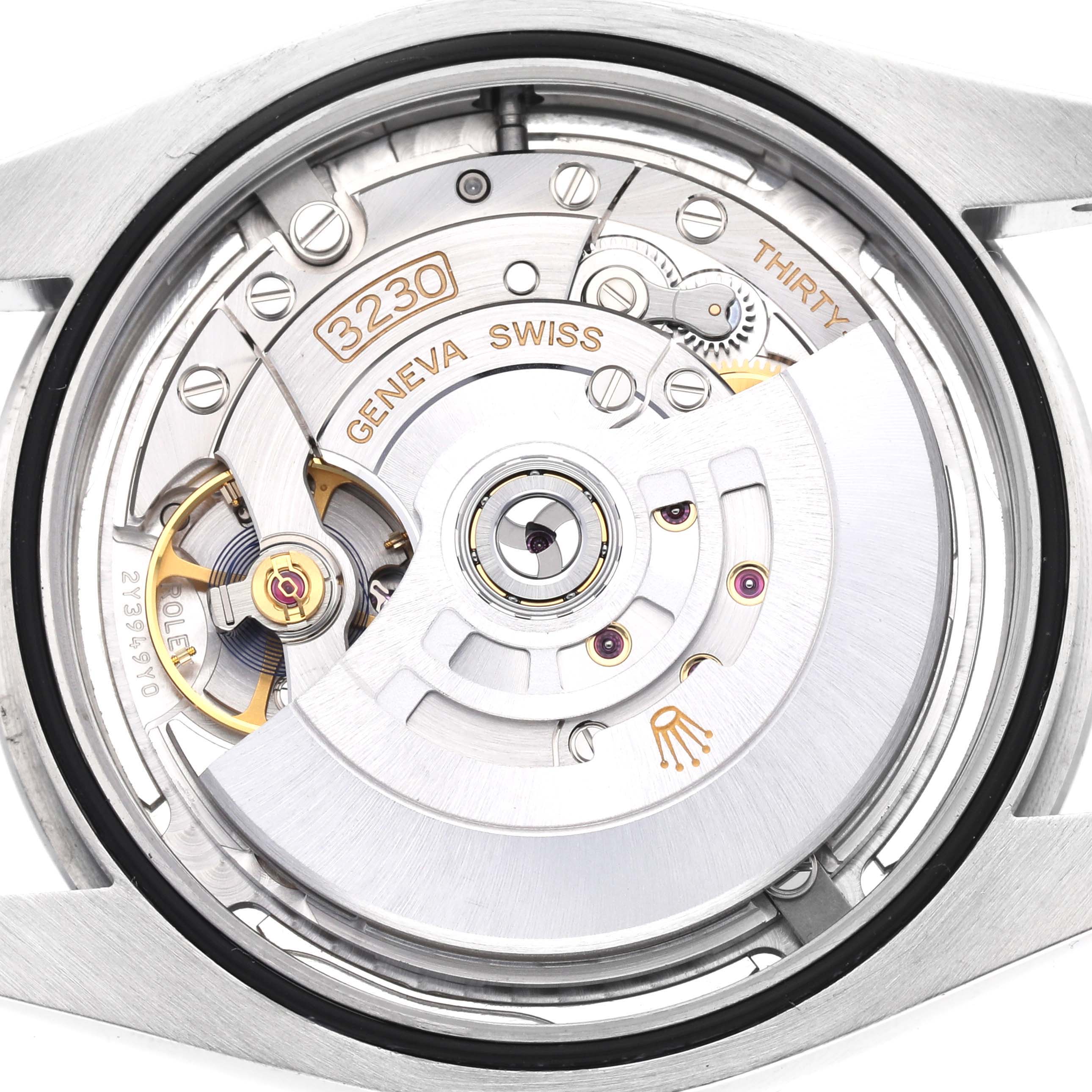 The image shows the movement of a Rolex Oyster Perpetual 124300 Men's Stainless Steel Silver Dial 124300 Men's Stainless Steel Silver Dial watch from a rear angle, highlighting the intricate gears and rotor.