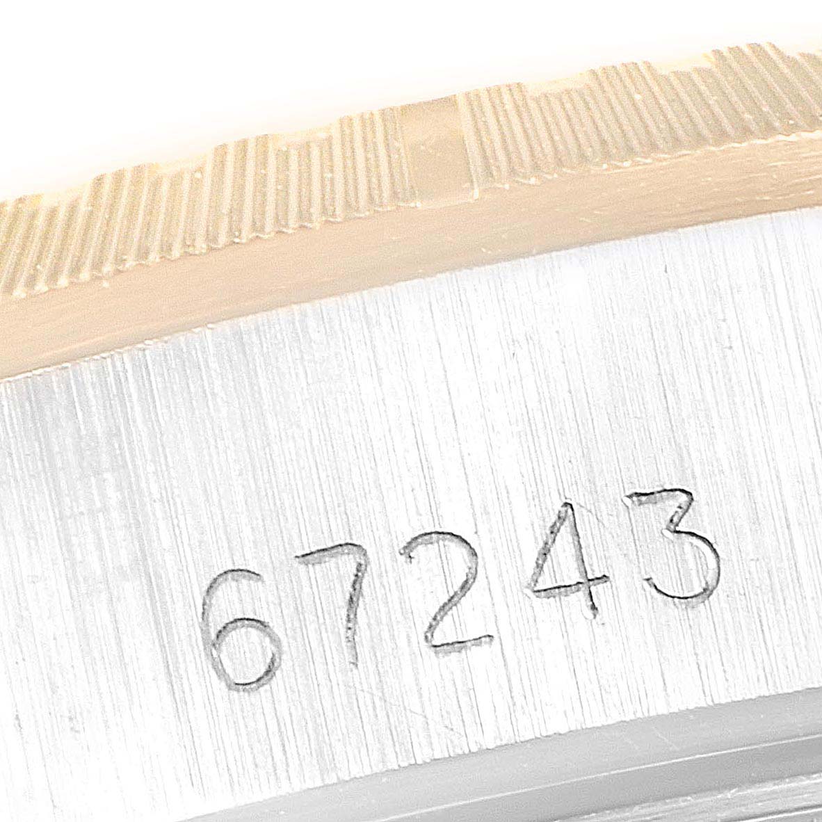This close-up image shows the serial number "67243" on the casing of a Rolex Oyster Perpetual 67243 Women's Steel and Gold (two tone) White Dial 67243 Women's Steel and Gold (two tone) White Dial watch.