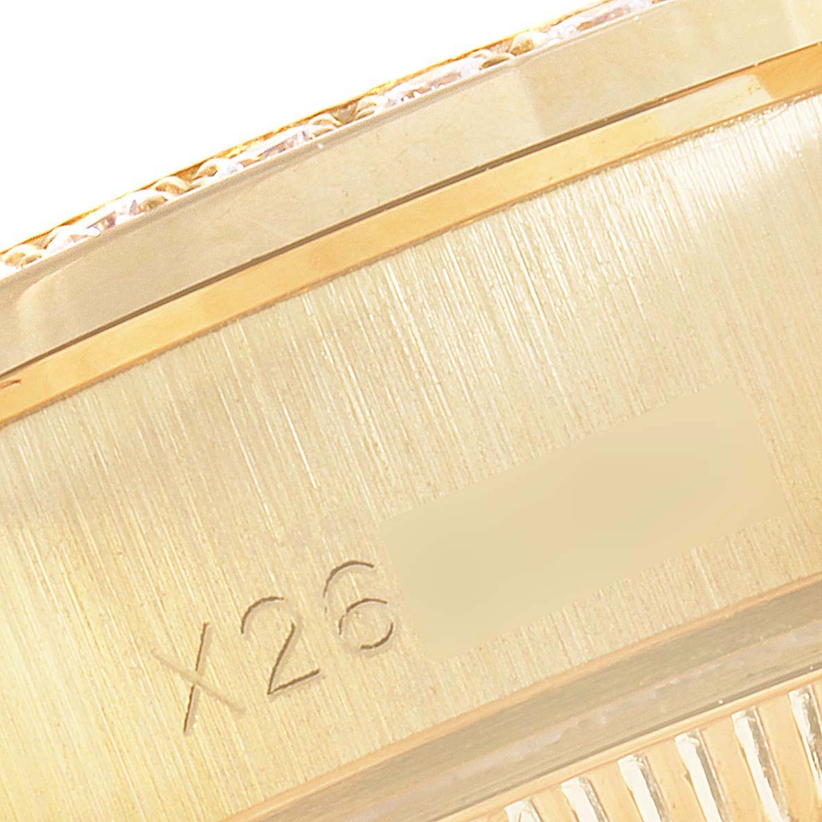 This close-up image shows a portion of the case edge of a Rolex President 69138 Women
s Yellow Gold Champagne Dial 69138 Women
s Yellow Gold Champagne Dial model watch, with the serial number partially visible.