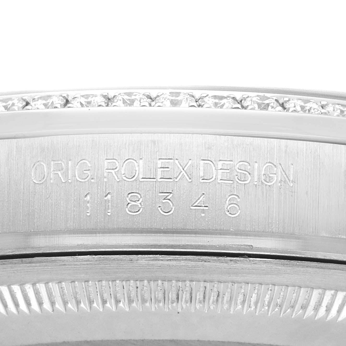 The image shows a close-up of the engraved case side and bezel of a Rolex President 118346 Men
s Platinum Silver Dial model, emphasizing the serial number.