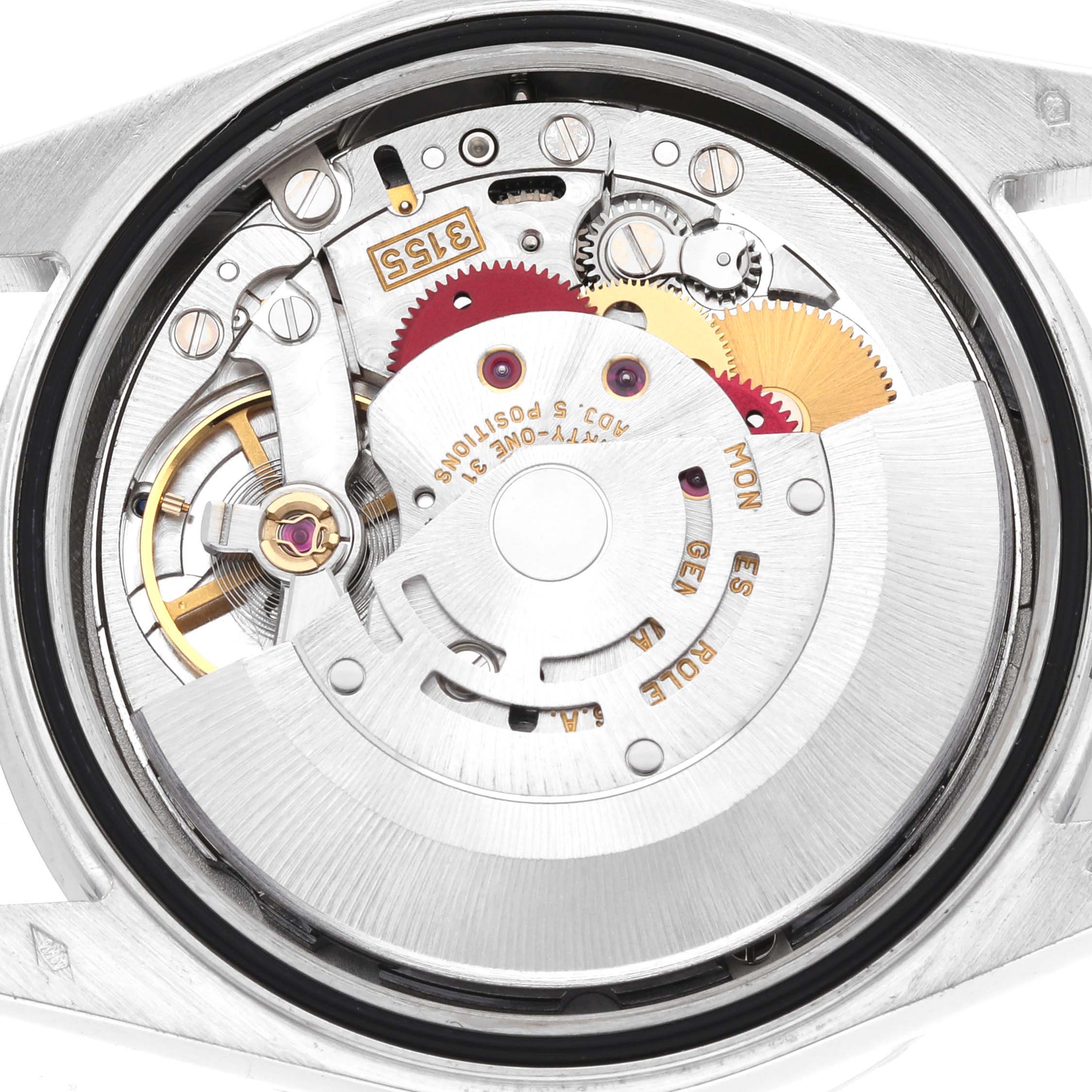 The image shows the internal automatic movement of a Rolex President 118366 Men
s Platinum Blue Dial model from a back view, revealing gears and the oscillating weight.