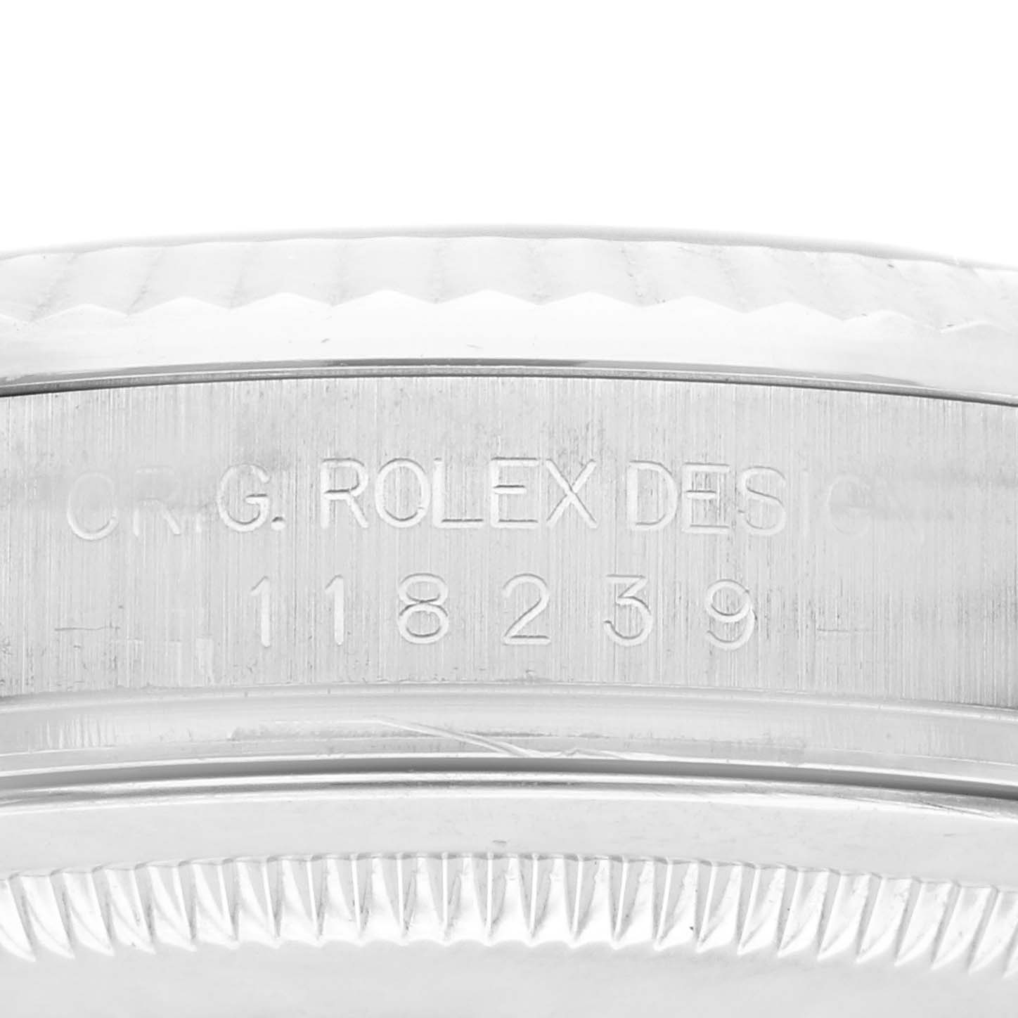 The image shows a close-up of the side of the Rolex President 118239 Men's White Gold Silver Dial 118239 Men's White Gold Silver Dial model, highlighting its design engraving and serial number.