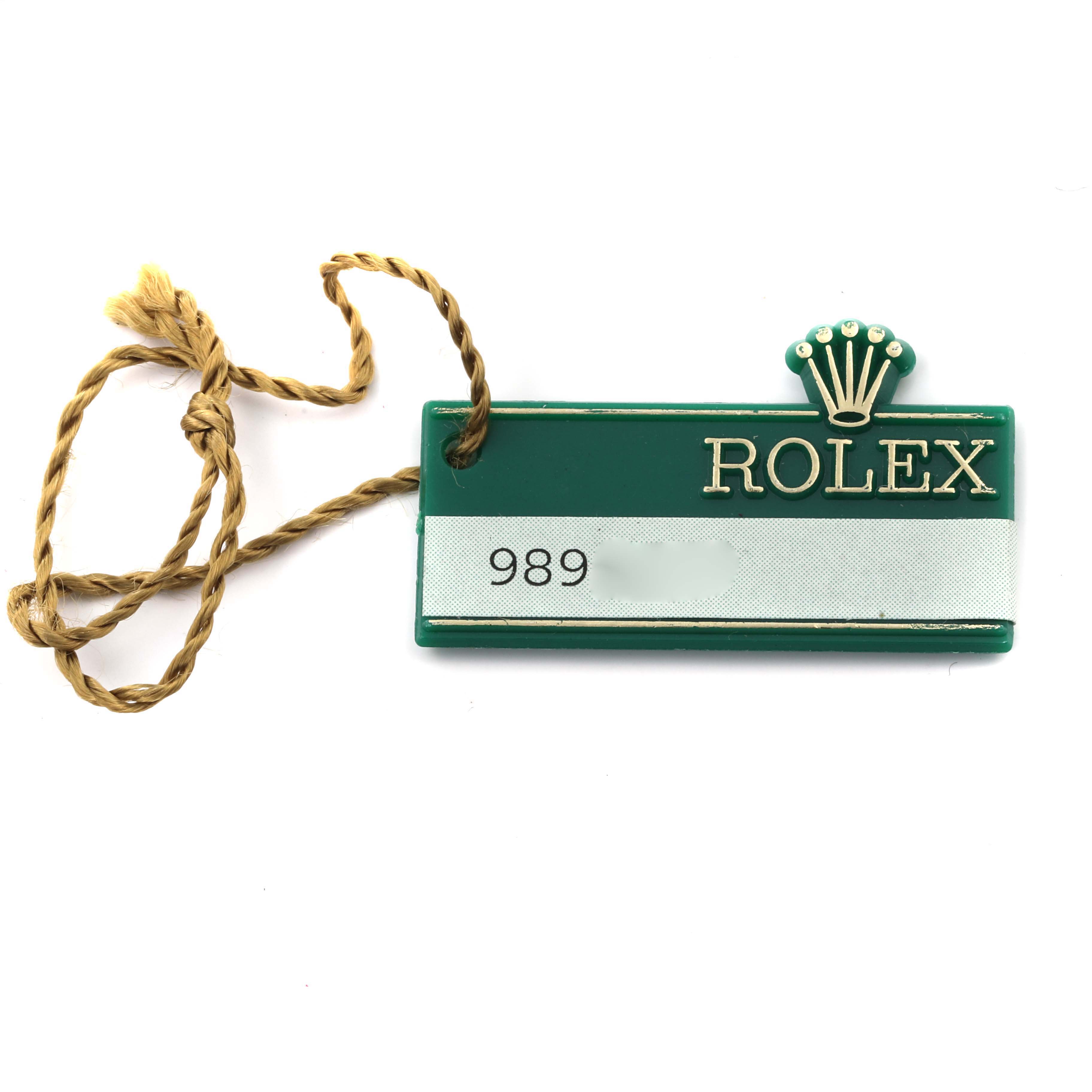 The image shows a Rolex President 68278 Women's Yellow Gold Champagne Dial 68278 Women's Yellow Gold Champagne Dial model green hang tag with a string attached.