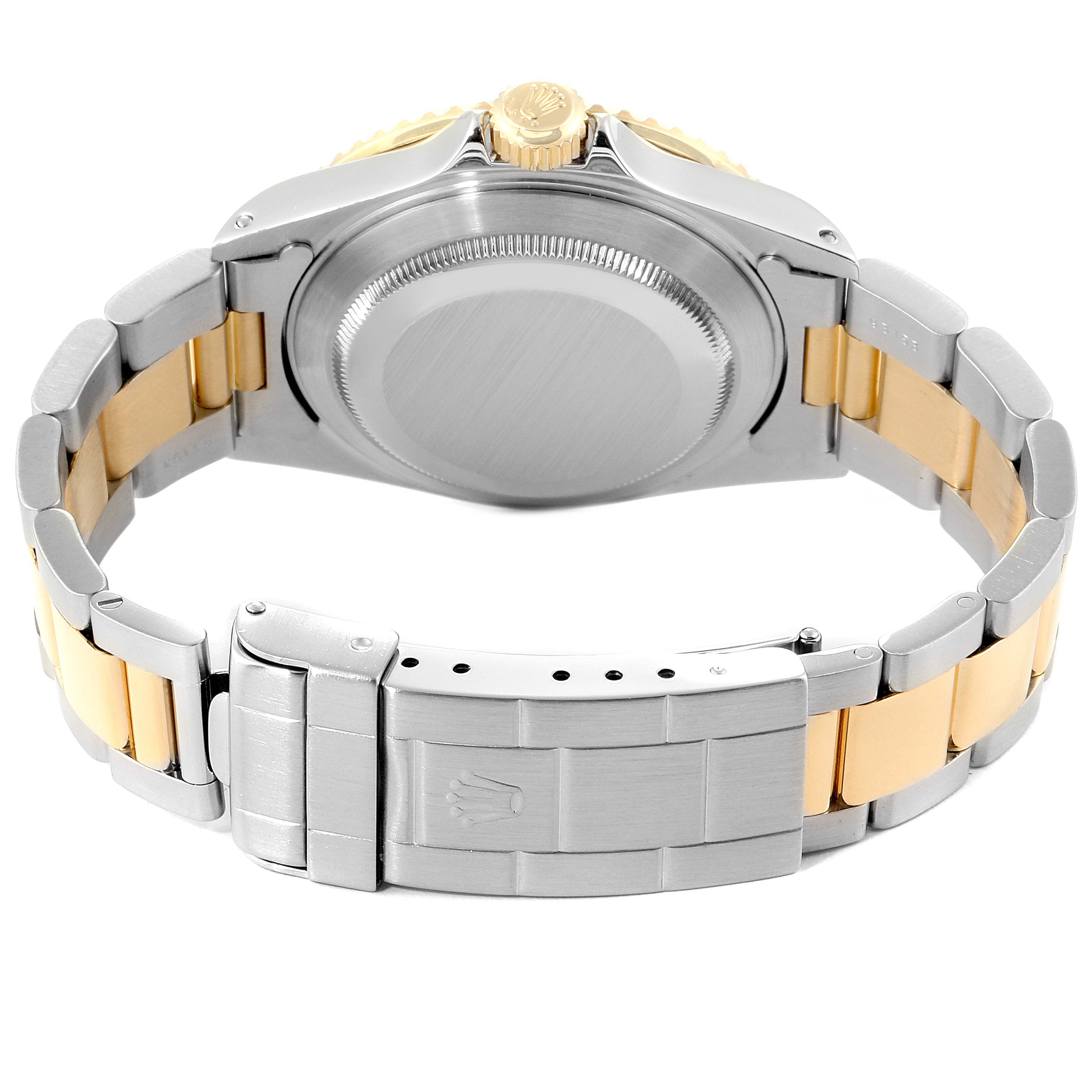 The image shows the back view of a Rolex Submariner 16613 Men's Steel and Gold (two tone) Blue Dial 16613 Men's Steel and Gold (two tone) Blue Dial watch, highlighting the case back, crown, and bracelet with clasp.