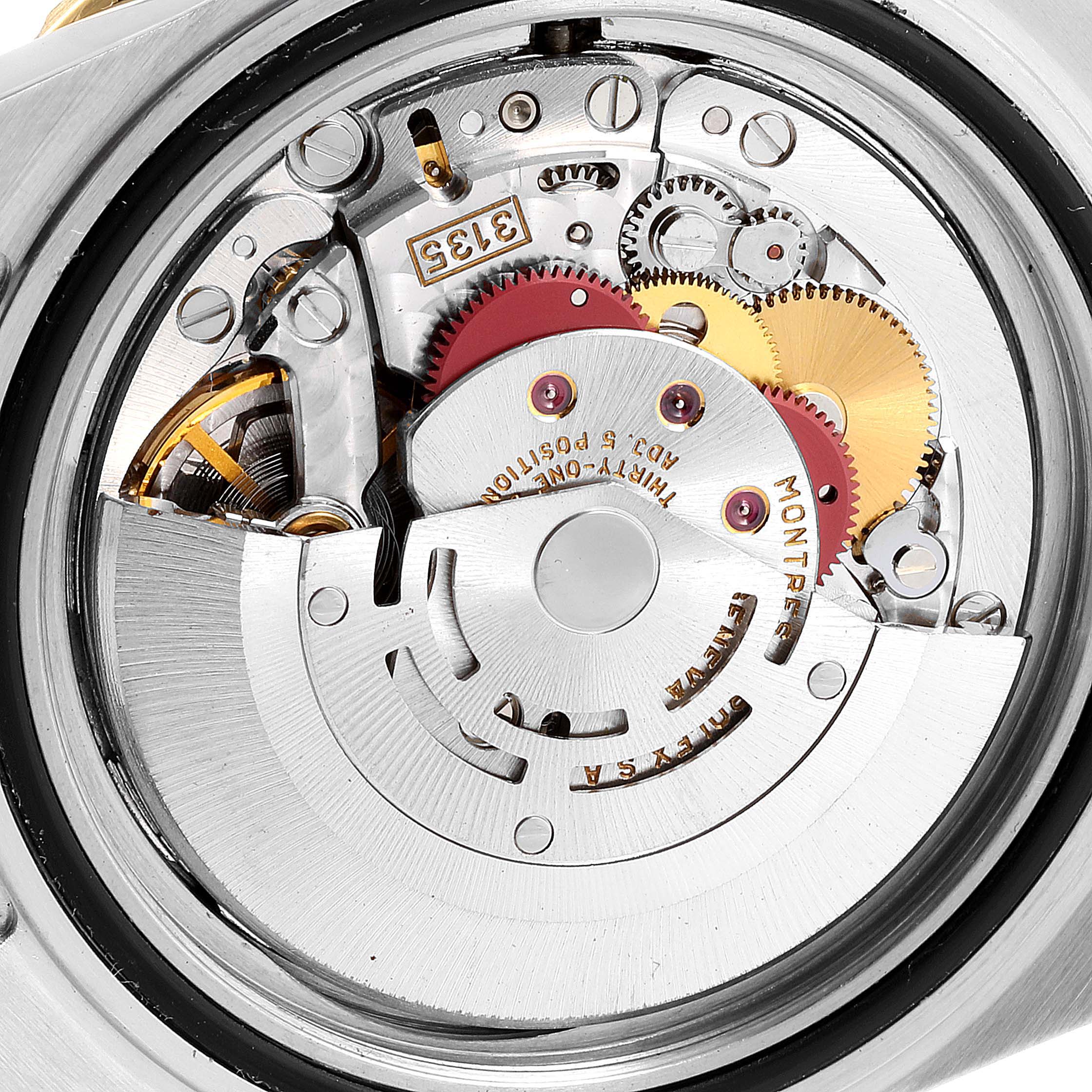 This image shows a close-up view of the internal mechanism of a Rolex Submariner 16613 Men's Steel and Gold (two tone) Blue Dial 16613 Men's Steel and Gold (two tone) Blue Dial watch, highlighting gears and components.