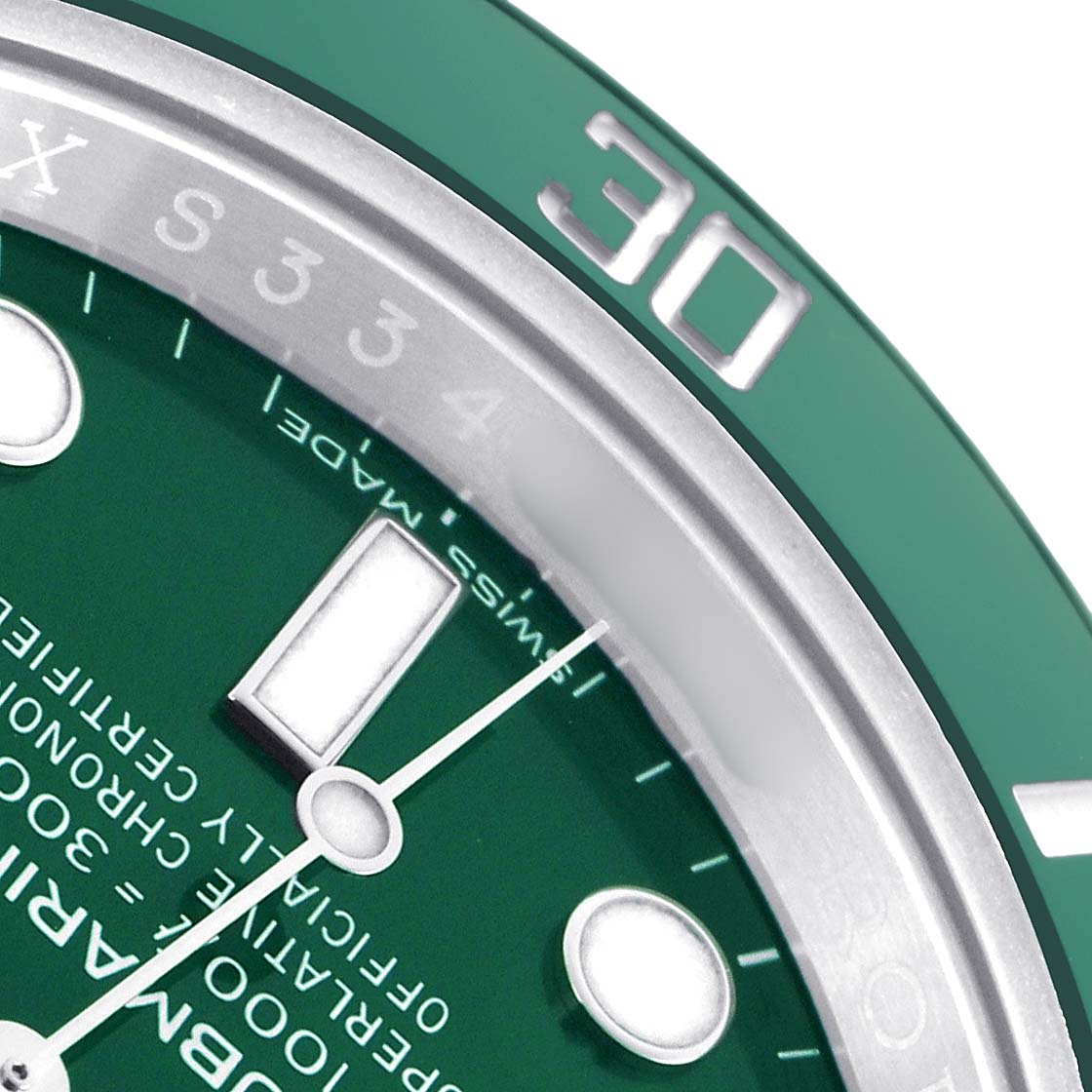 The image shows a close-up of the Rolex Submariner 116610LV Men
s Stainless Steel Green Dial
s dial and part of the bezel, focusing on the 30-minute marker.