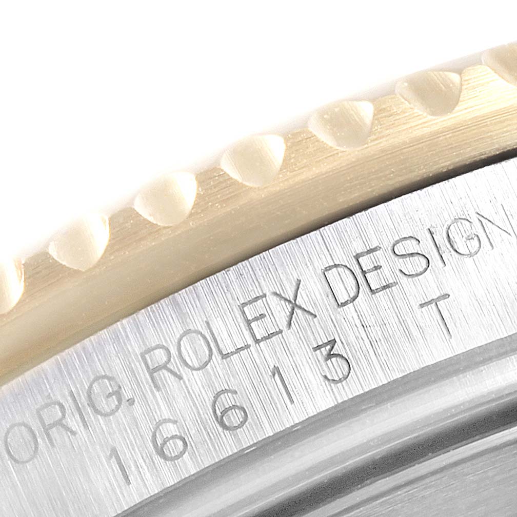 This close-up image shows the bezel and side engraving of a Rolex Submariner 16613 Men
s Steel and Gold (two tone) Grey Dial 16613 Men
s Steel and Gold (two tone) Grey Dial watch.