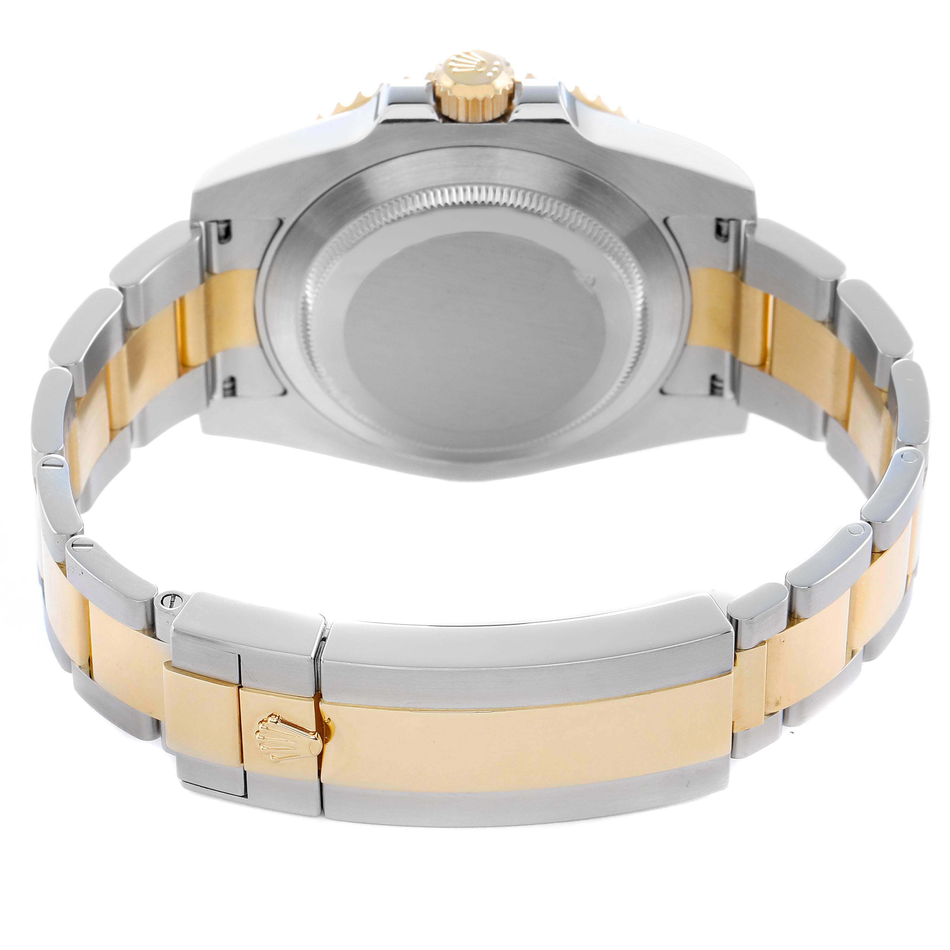 The image shows the back view of a Rolex Submariner 116613 Men
s Steel and Gold (two tone) Blue Dial, highlighting the case, crown, and two-tone bracelet with clasp.