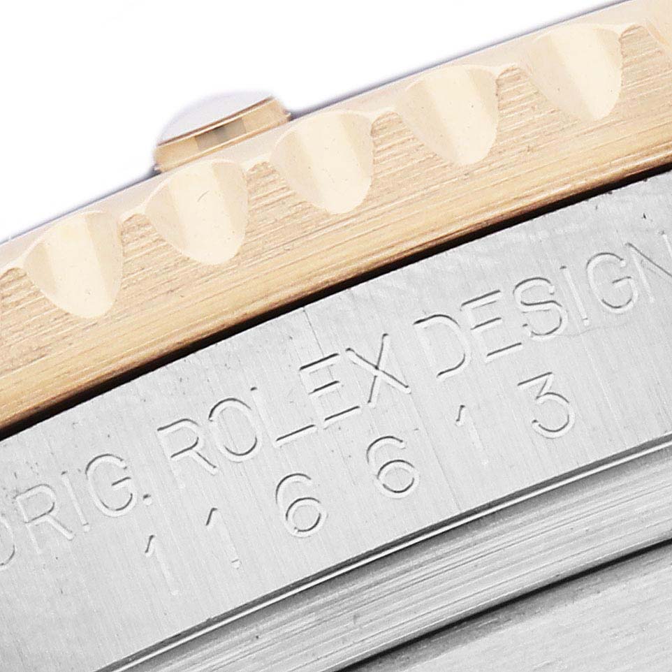 The image shows a close-up of the Rolex Submariner 116613 Men
s Steel and Gold (two tone) Blue Dial model
s bezel and engraved case side.