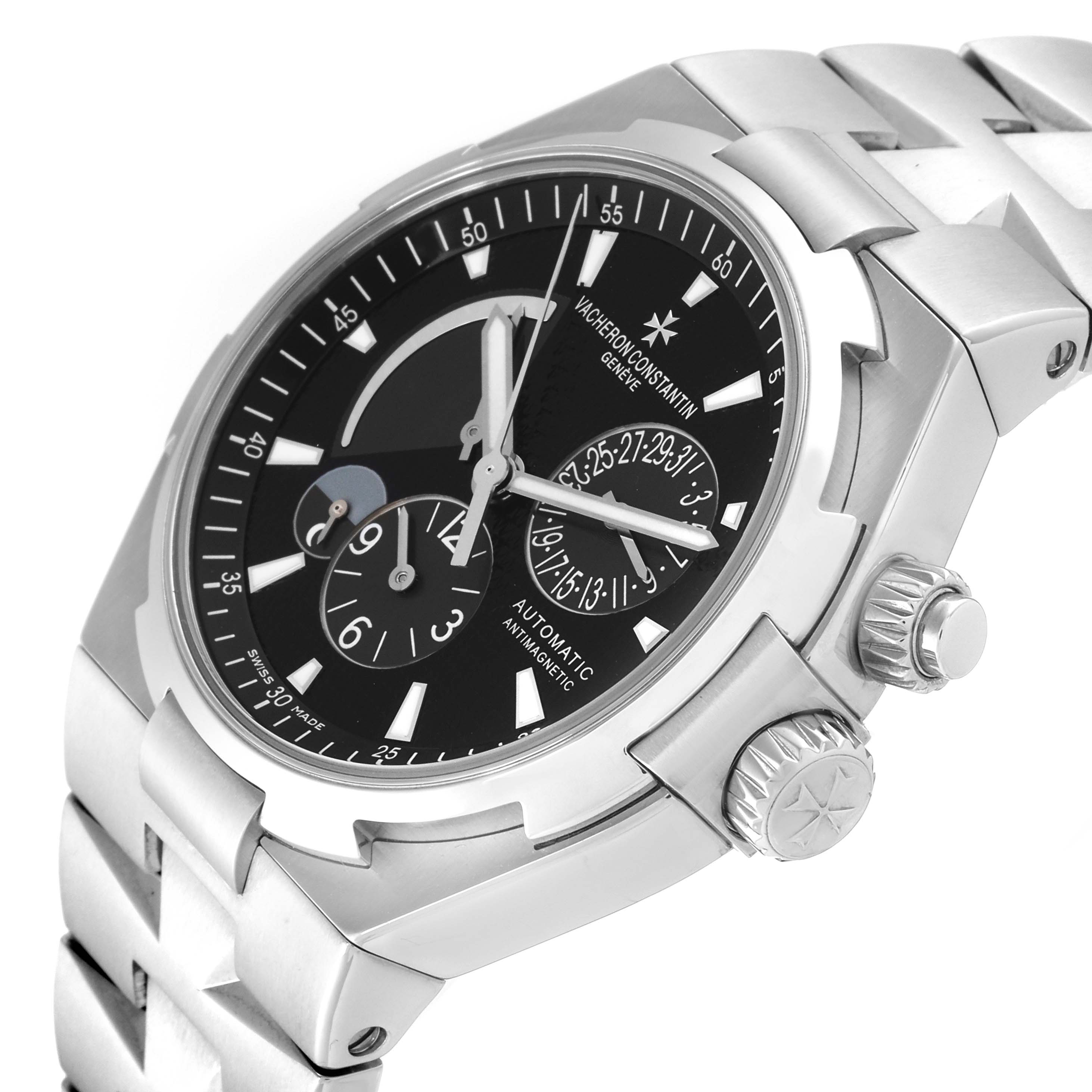 The image shows a Vacheron Constantin Overseas 47450/B01A-9227 Men's Stainless Steel Black Dial 47450/B01A-9227 Men's Stainless Steel Black Dial model watch at a three-quarter angle, highlighting the dial, crown, and part of the bracelet.