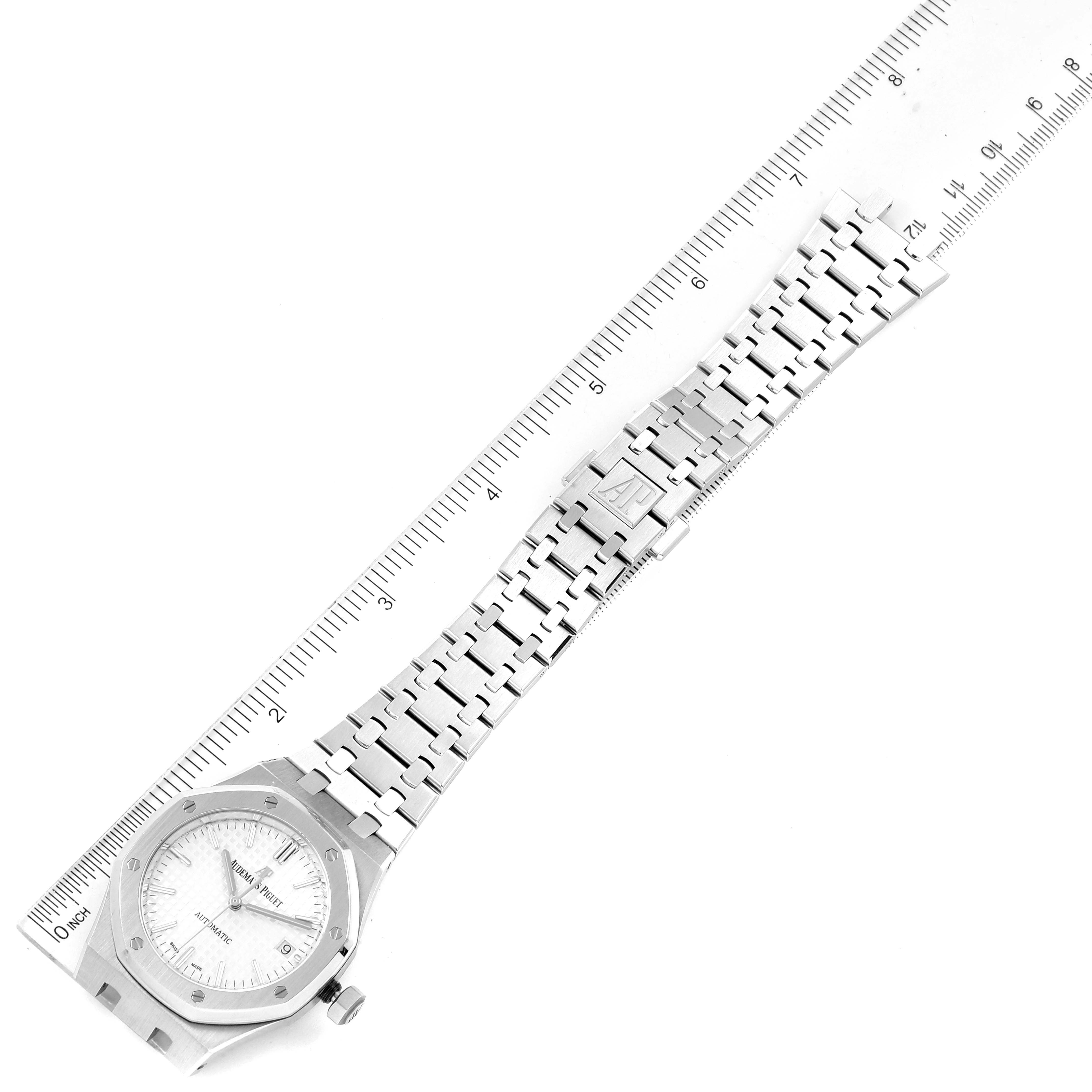The image shows an Audemars Piguet Royal Oak 15450ST.OO.1256ST.01 Men's Stainless Steel Silver Dial 15450ST.OO.1256ST.01 Men's Stainless Steel Silver Dial watch laying flat with its bracelet and clasp fully extended, next to a ruler for scale.