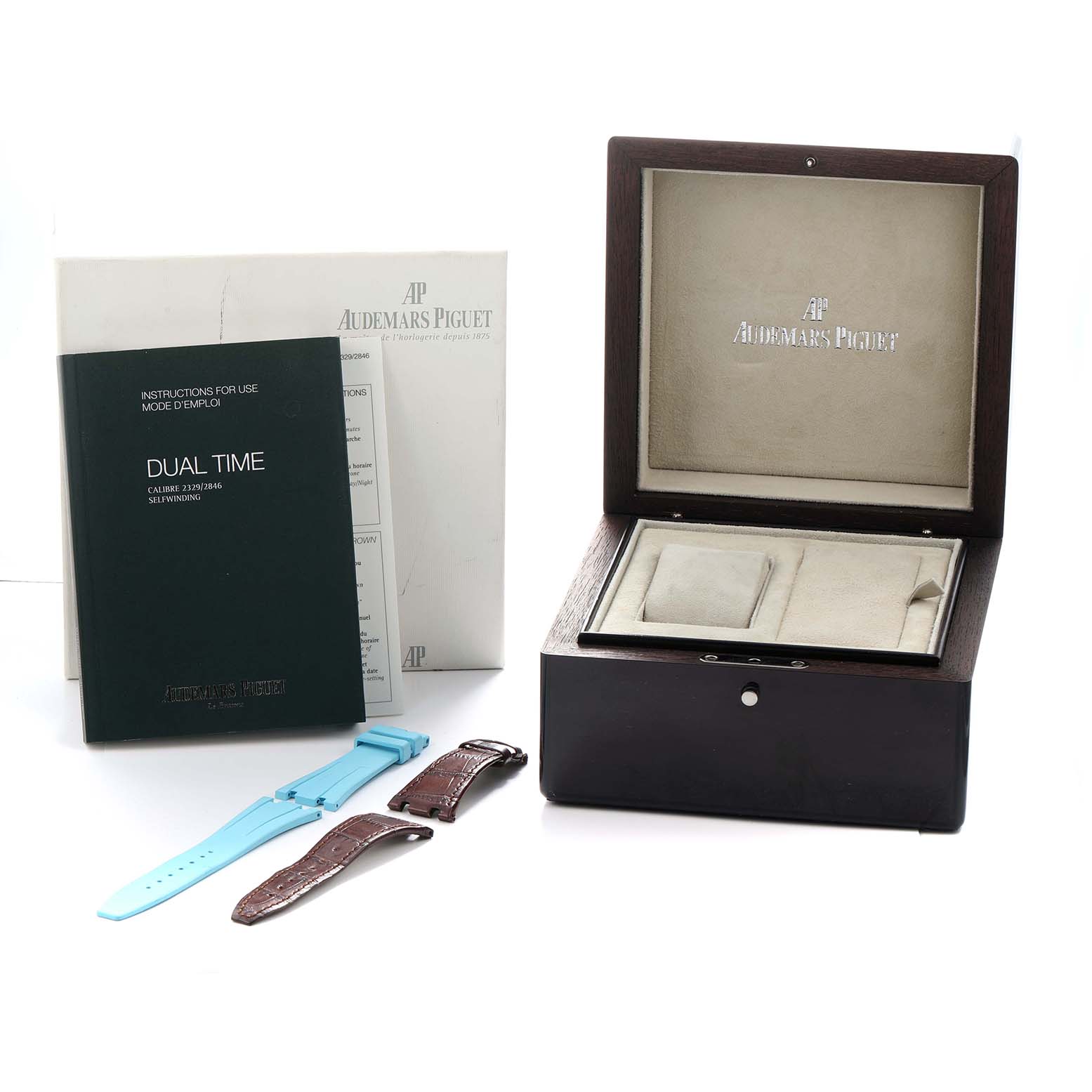 The image shows an Audemars Piguet Royal Oak 26120OR Men
s Rose Gold Black Dial box, extra straps, and manuals from a top angle.